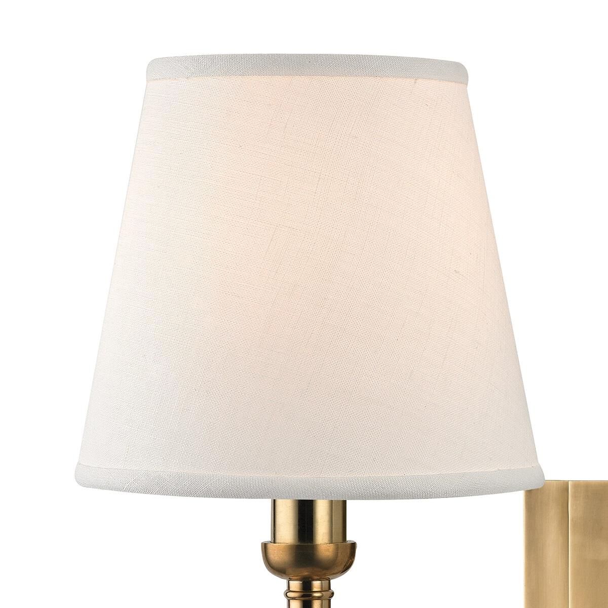Shown in Aged Brass finish and White Linen shade