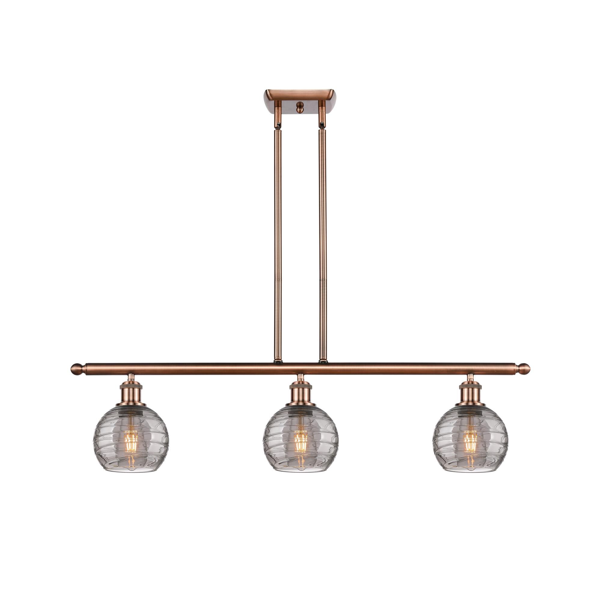 Shown in Antique Copper finish and Light Smoke Deco Swirl glass