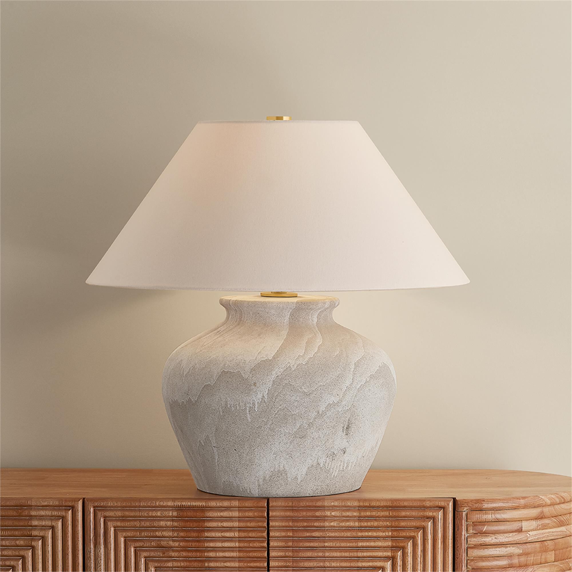 Shown in Aged Brass and Ceramic Watercolor Sand finish and White Linen shade