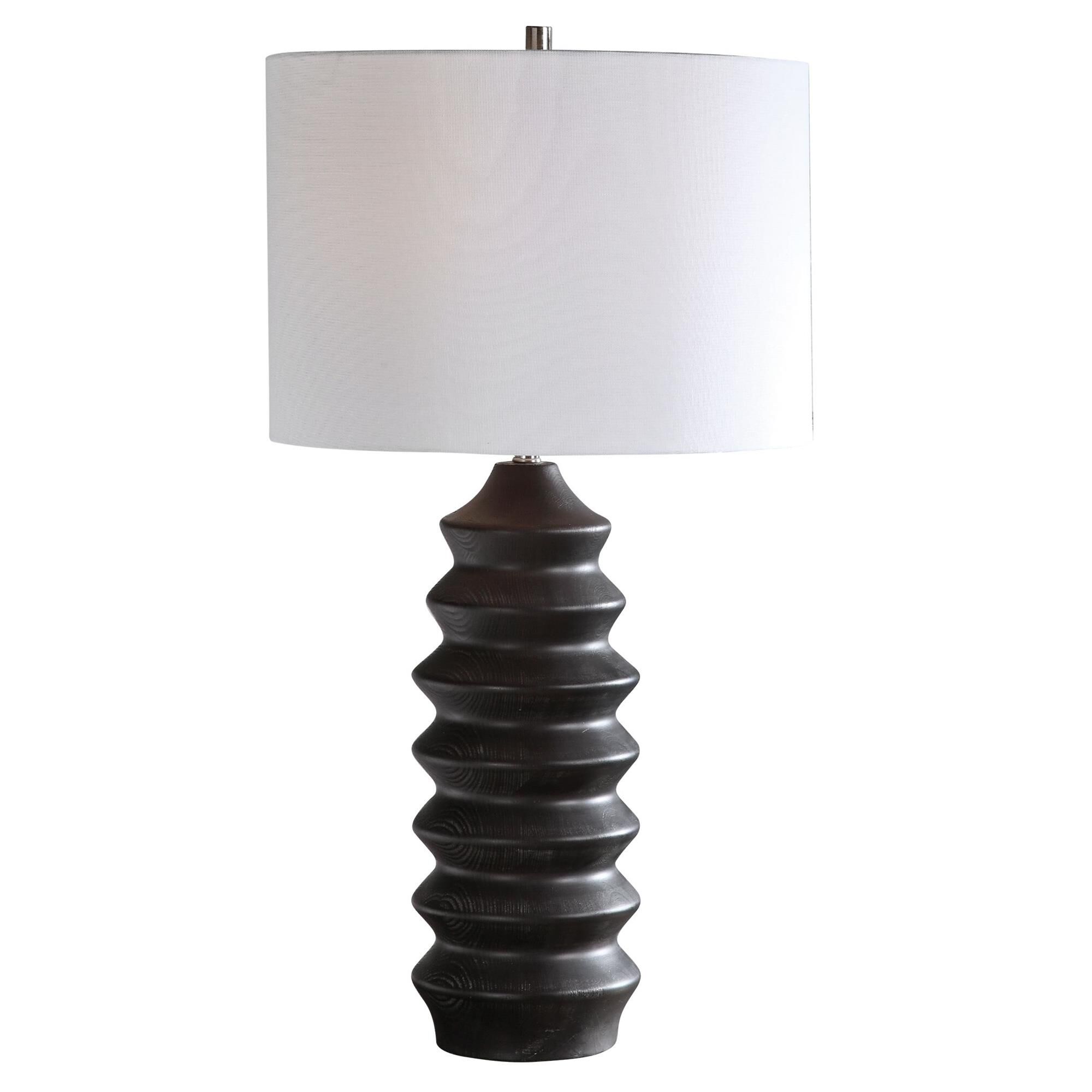 Shown in Showcasing A Modern Lodge Style, This Table Lamp Features A Carved Wood Base Finished In A Rustic Bl finish and Round Drum Hardback shade