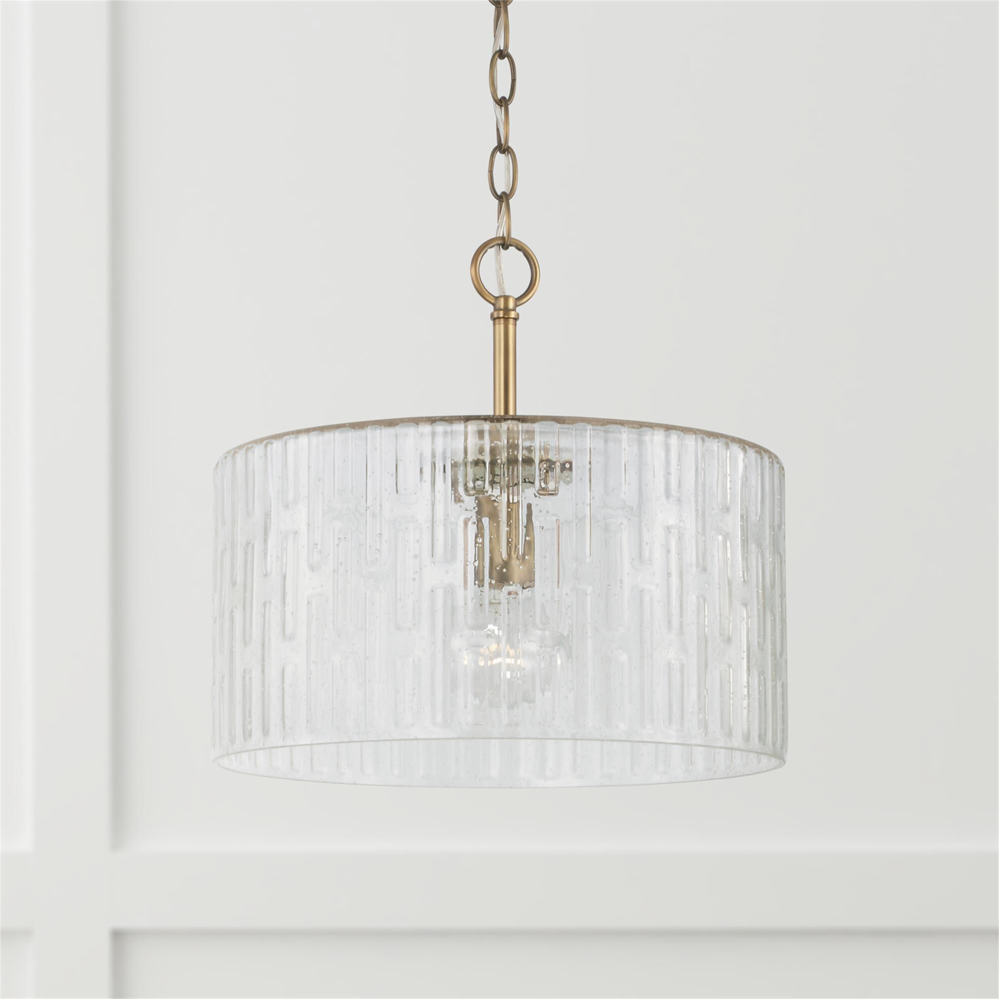 Shown in Aged Brass finish and Embossed Seeded glass