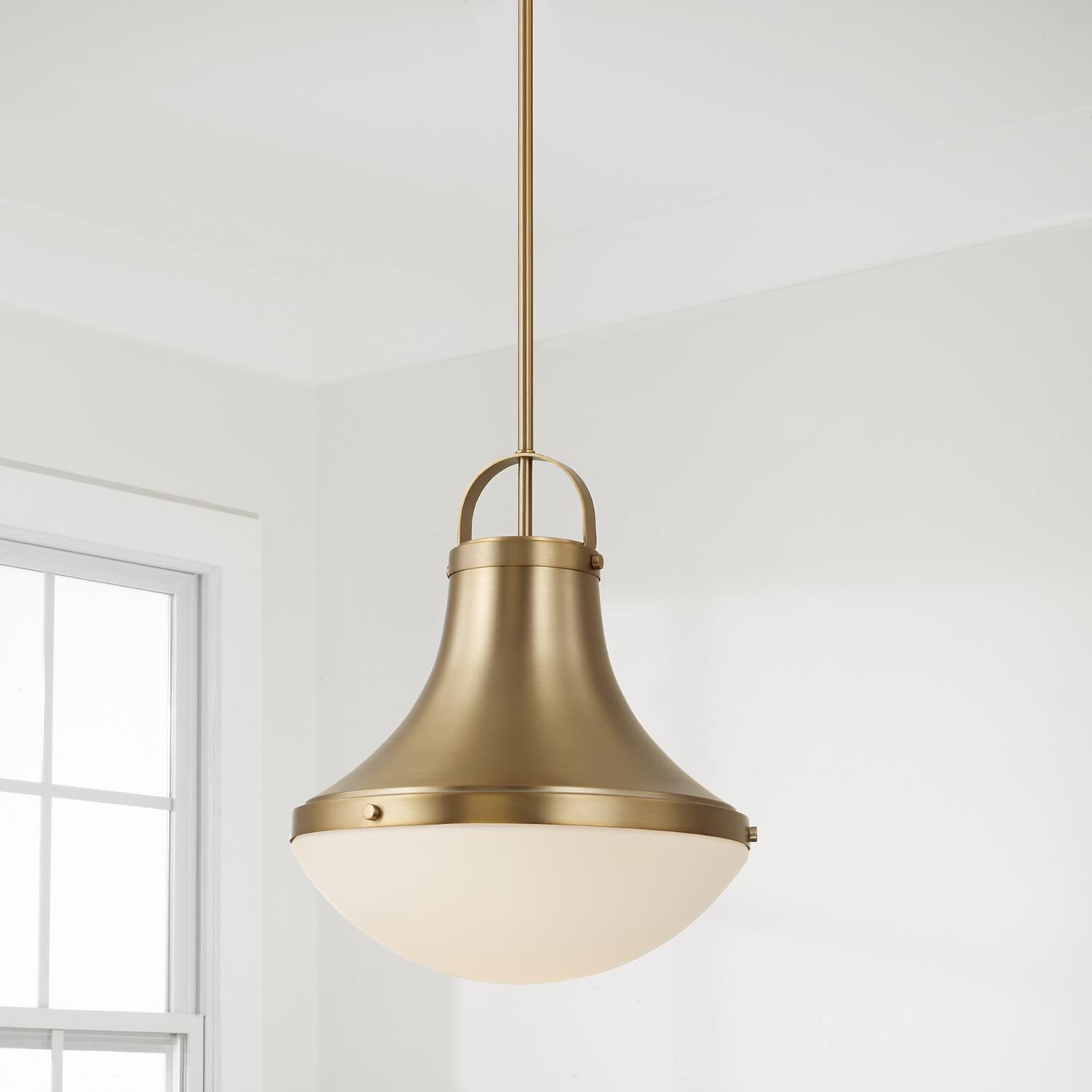 Shown in Aged Brass finish and Soft White glass