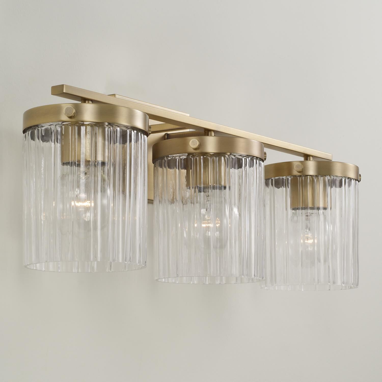 Shown in Aged Brass finish and Beveled Fluted glass