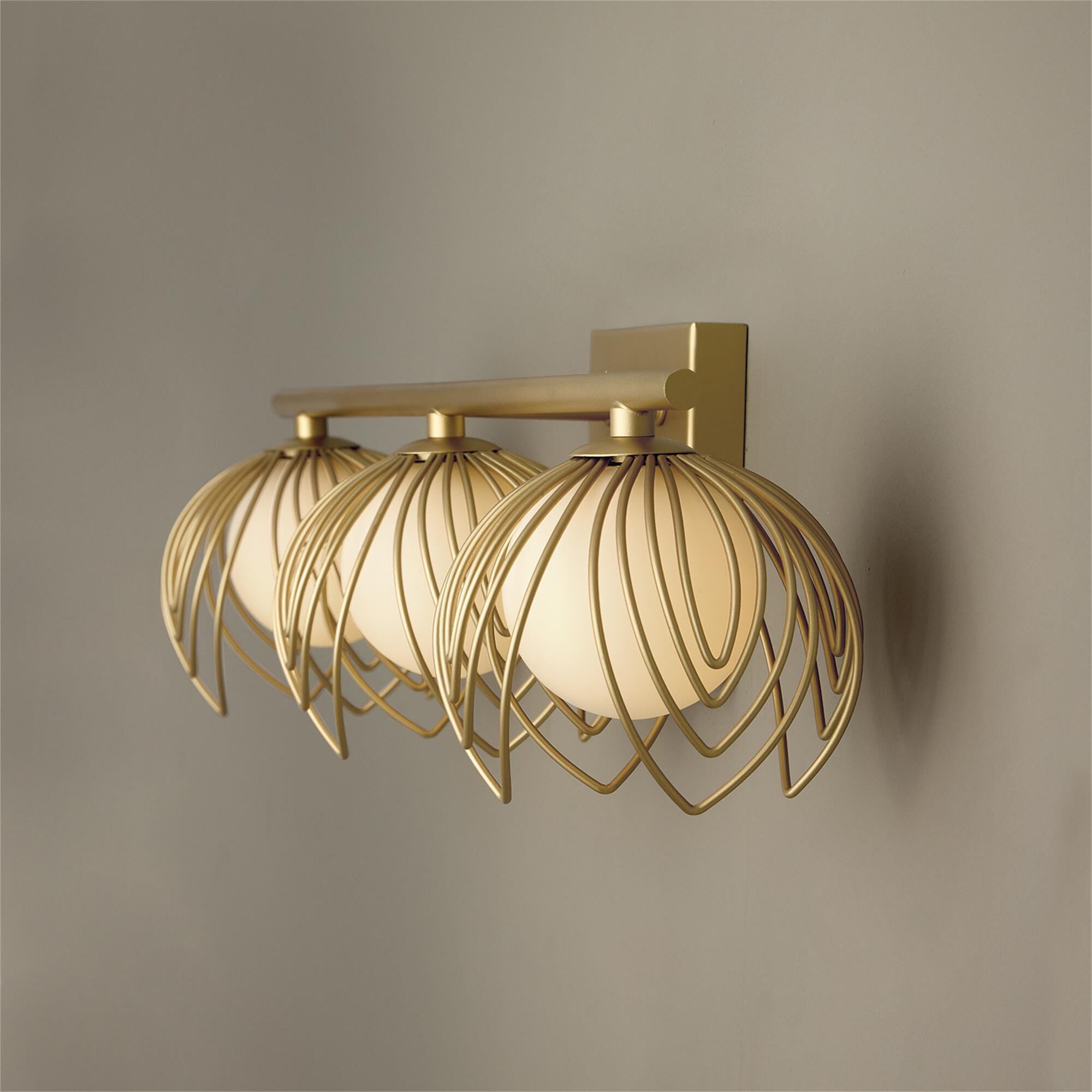 Shown in Buffed Gold finish and Soft White Globes glass