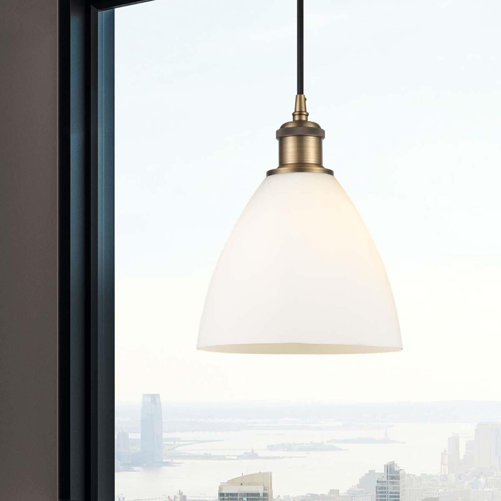 Shown in Brushed Brass finish and Matte White glass
