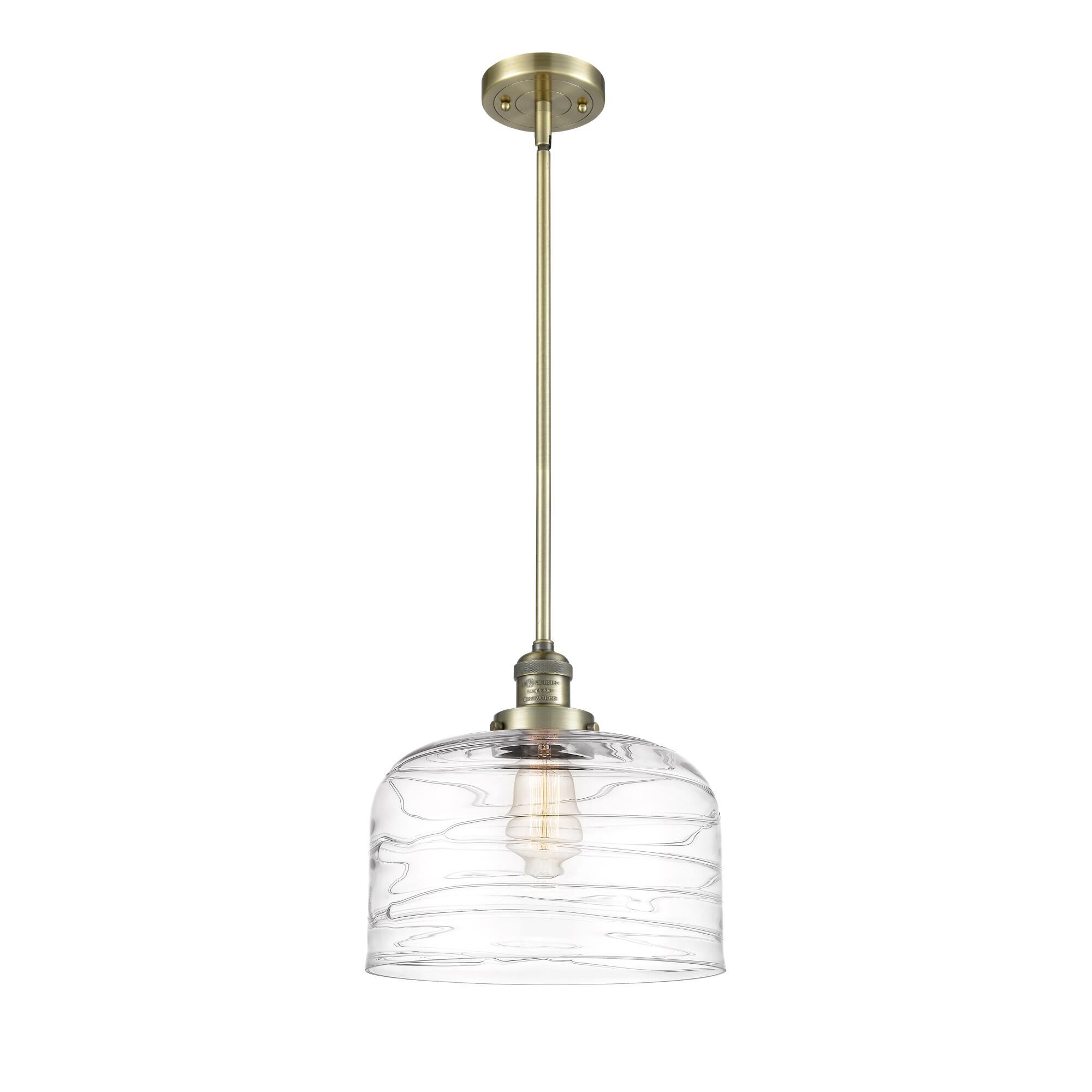 Shown in Antique Brass finish and Clear Deco Swirl X-Large Bell glass