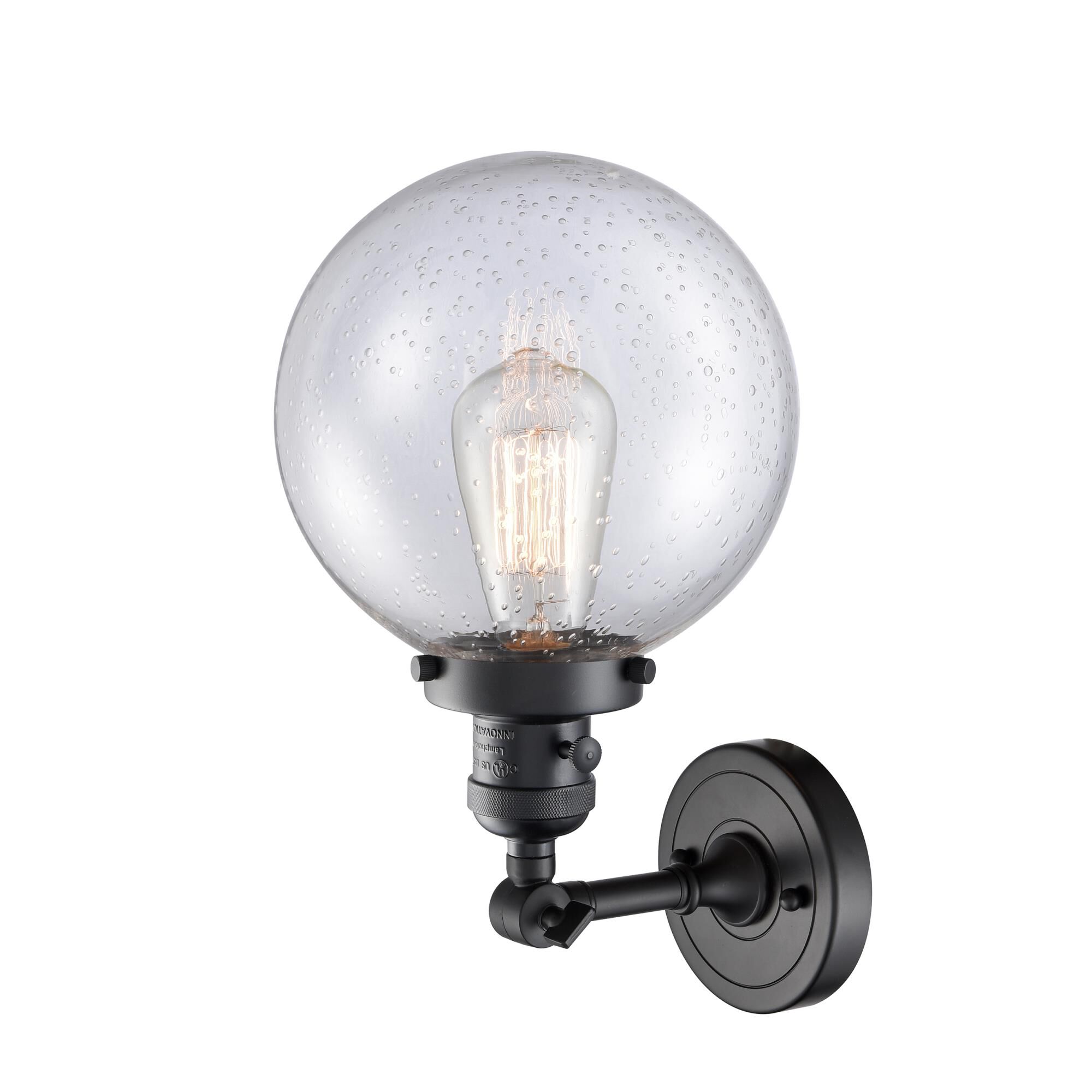 Shown in Matte Black finish and Seedy glass and Switch on Socket accent