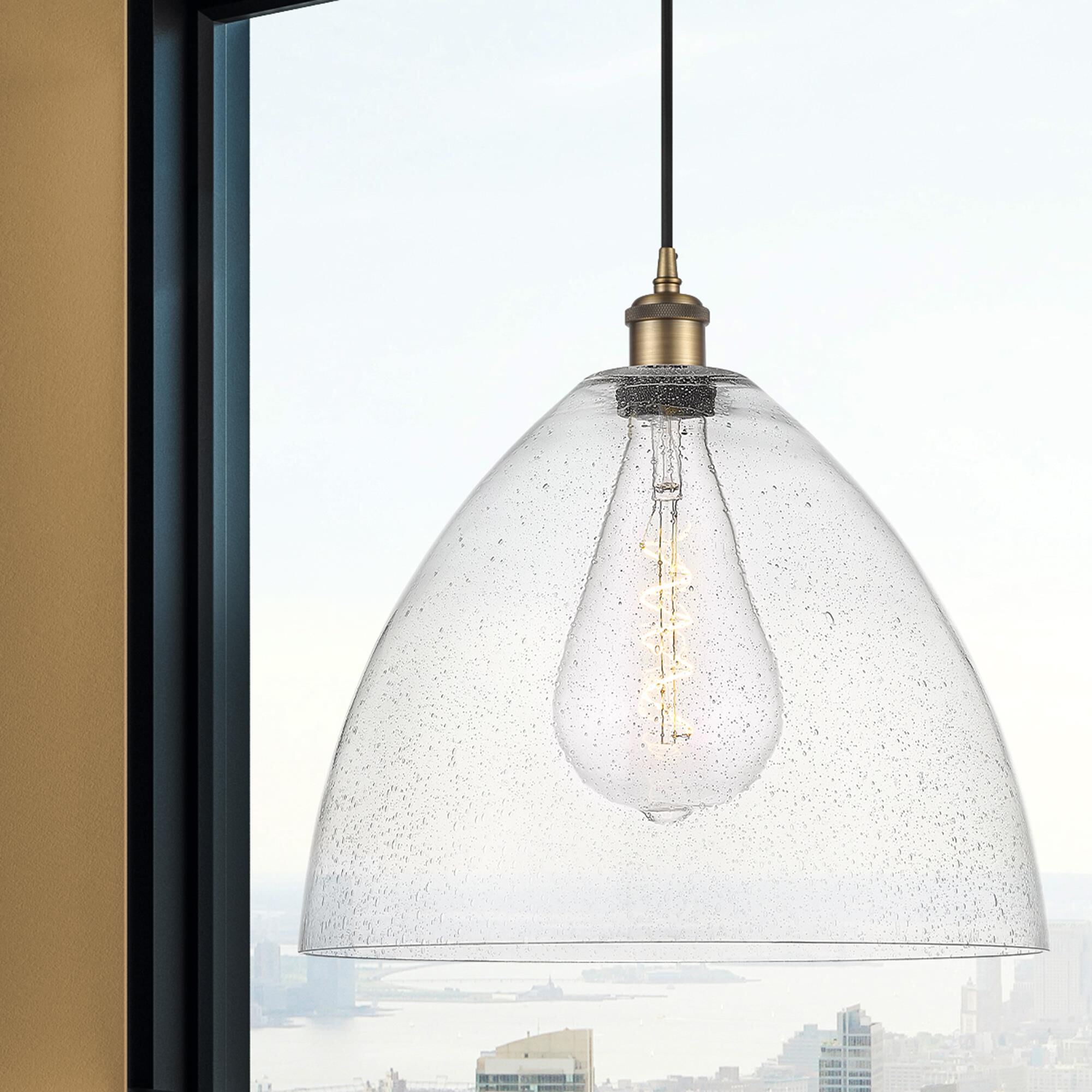 Shown in Brushed Brass finish and Seedy glass