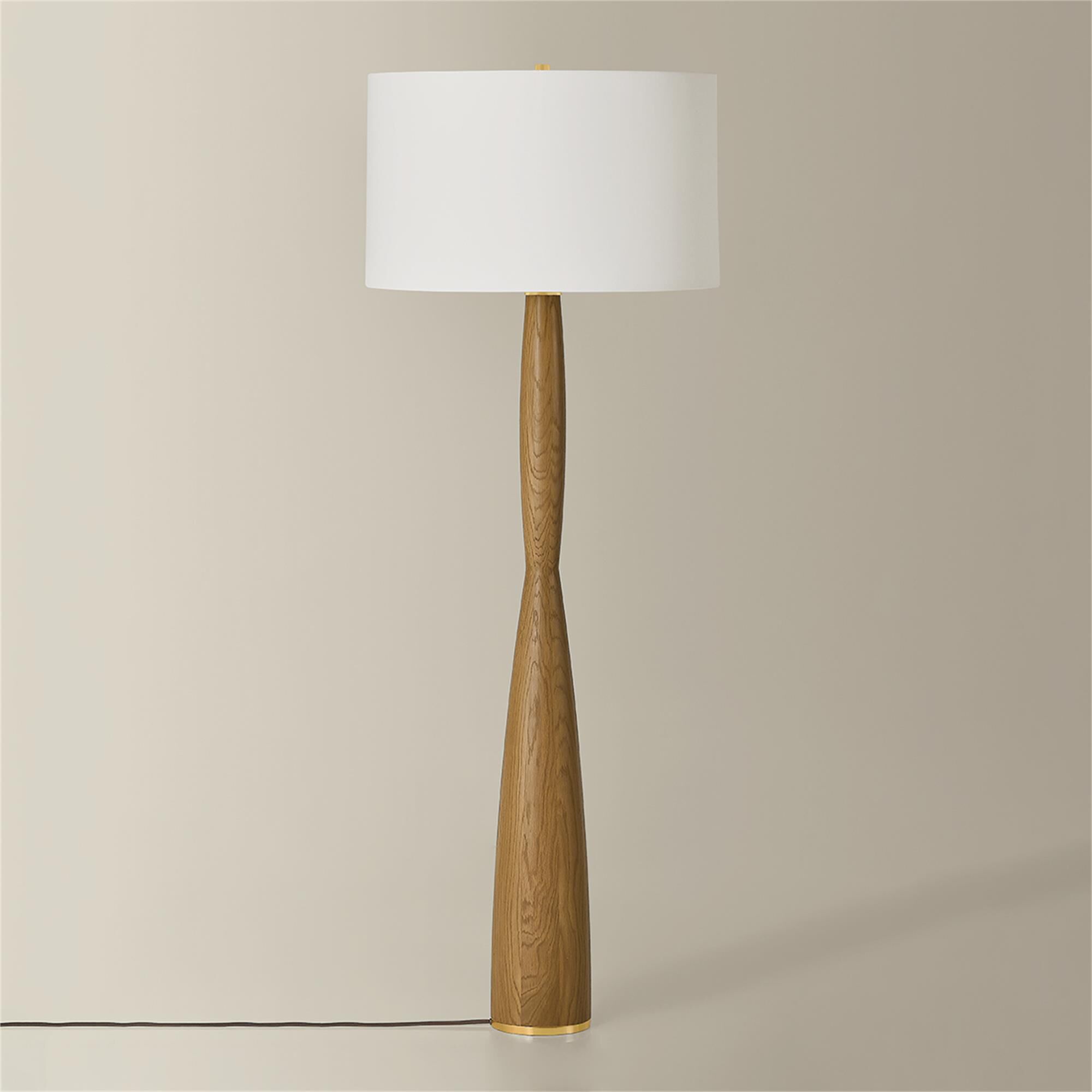 Shown in Aged Brass finish and White Linen shade