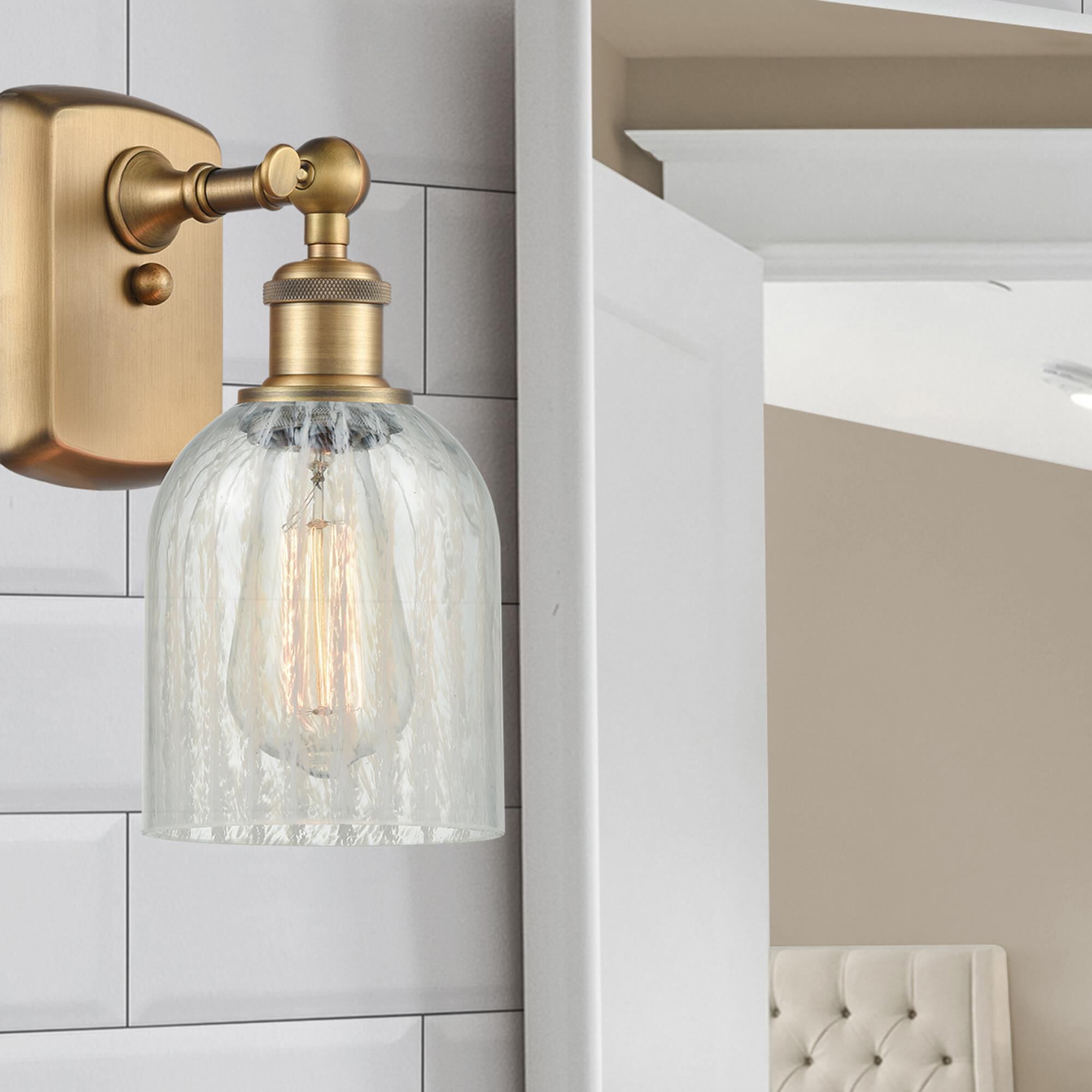 Shown in Brushed Brass finish and Bell glass and Glass shade