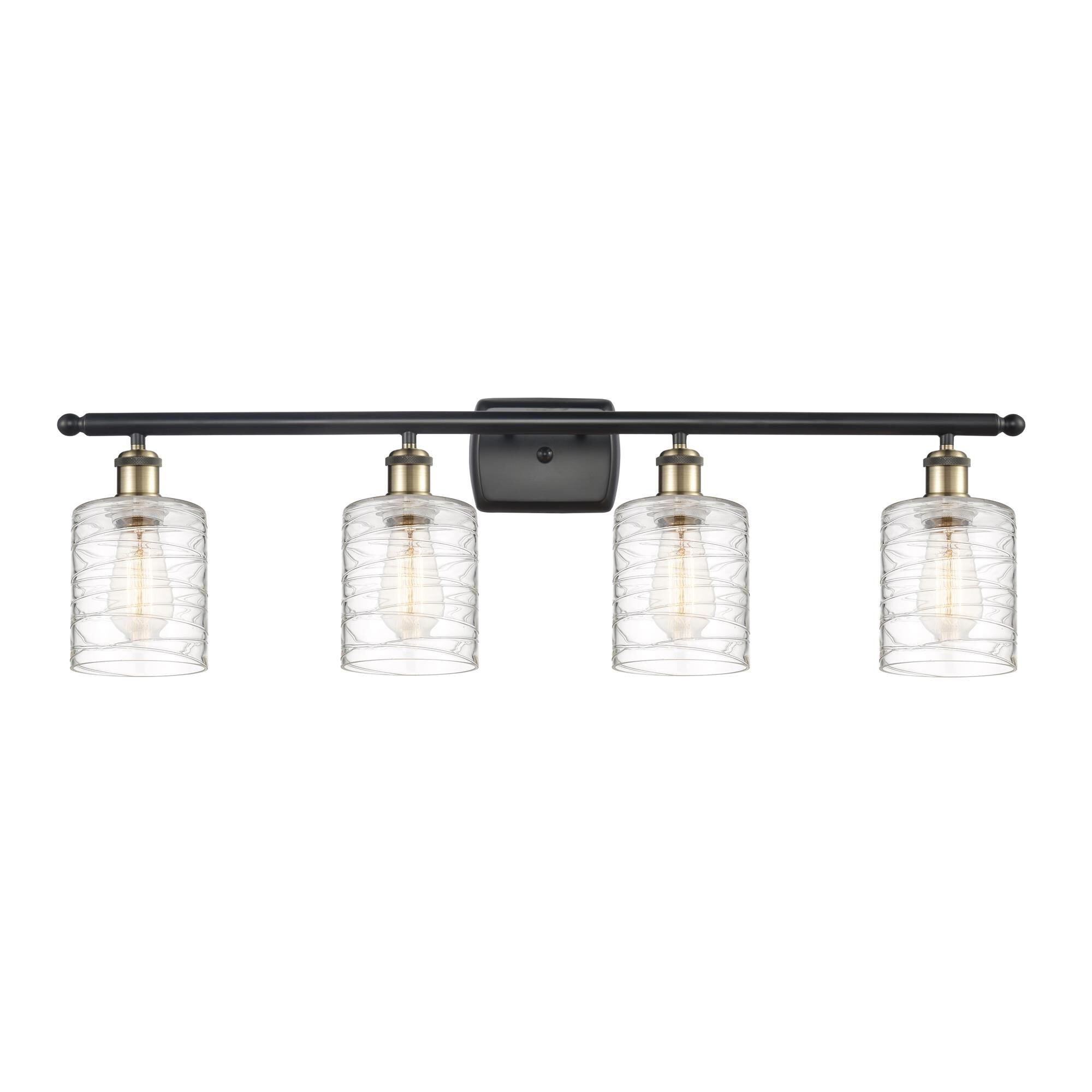 Shown in Black Antique Brass finish and Deco Swirl Cobbleskill glass