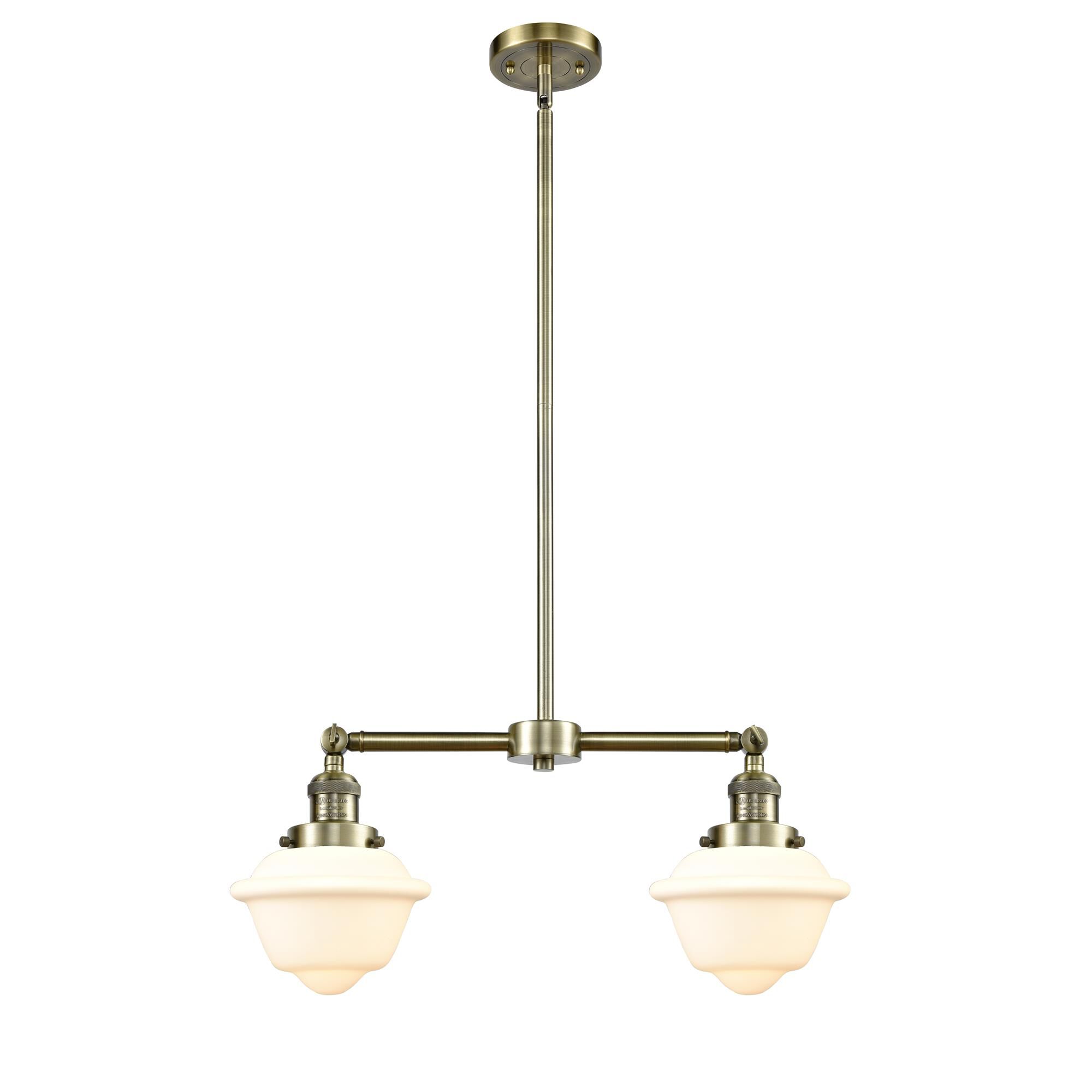 Shown in Antique Brass finish and Matte White Cased glass