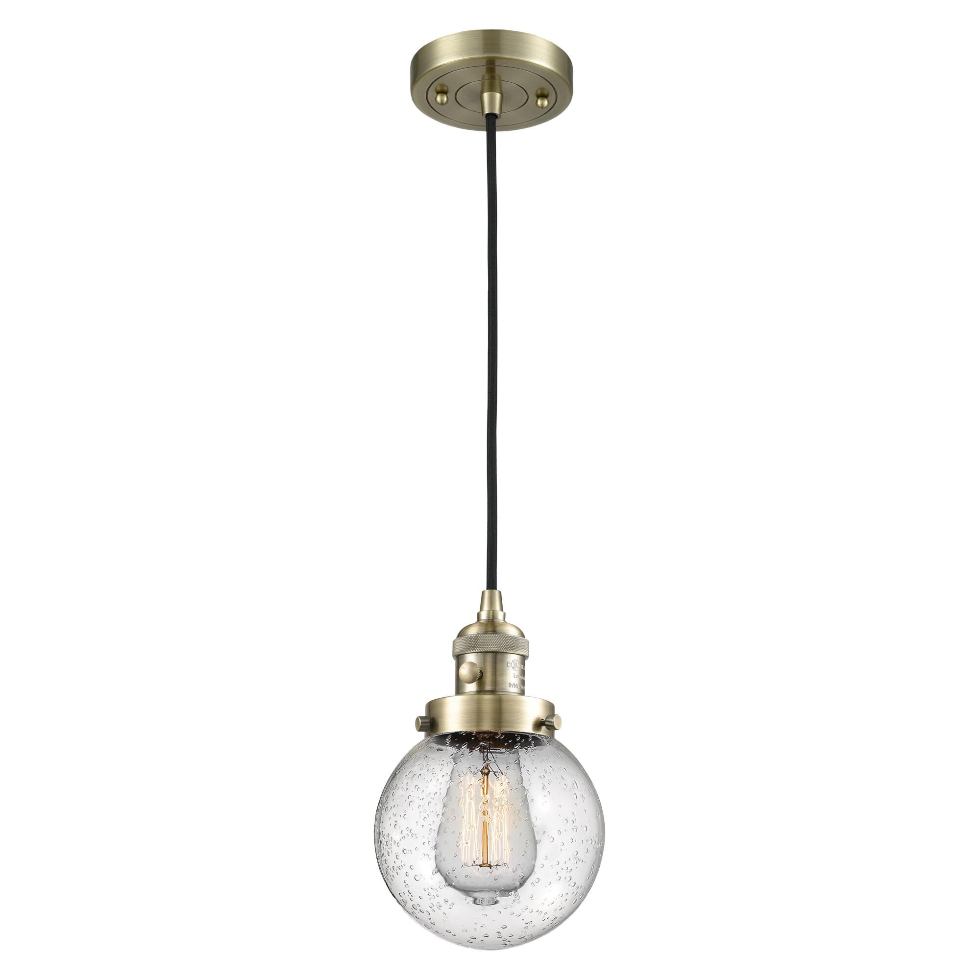 Shown in Antique Brass finish and Seedy glass