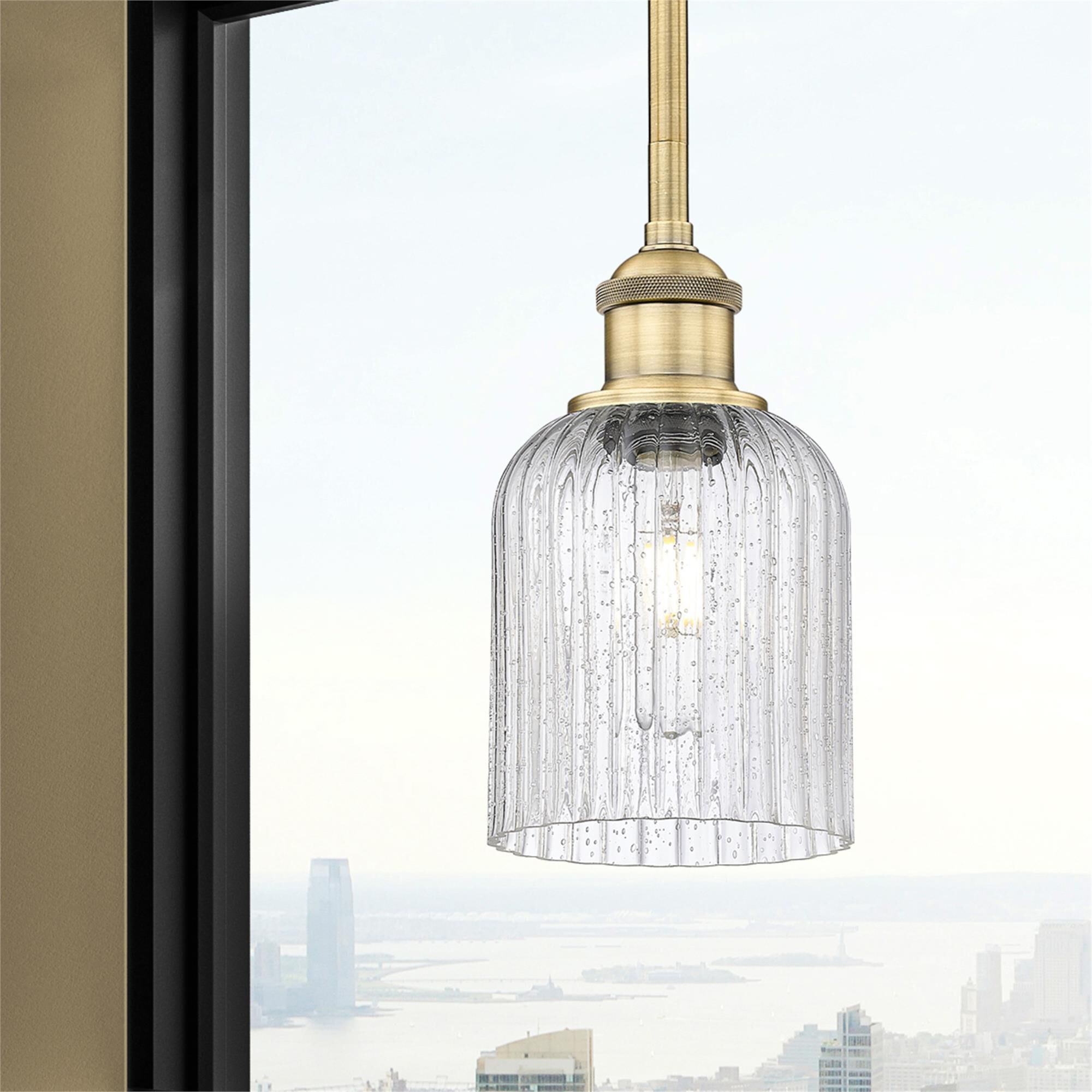 Shown in Brushed Brass finish and Seedy glass