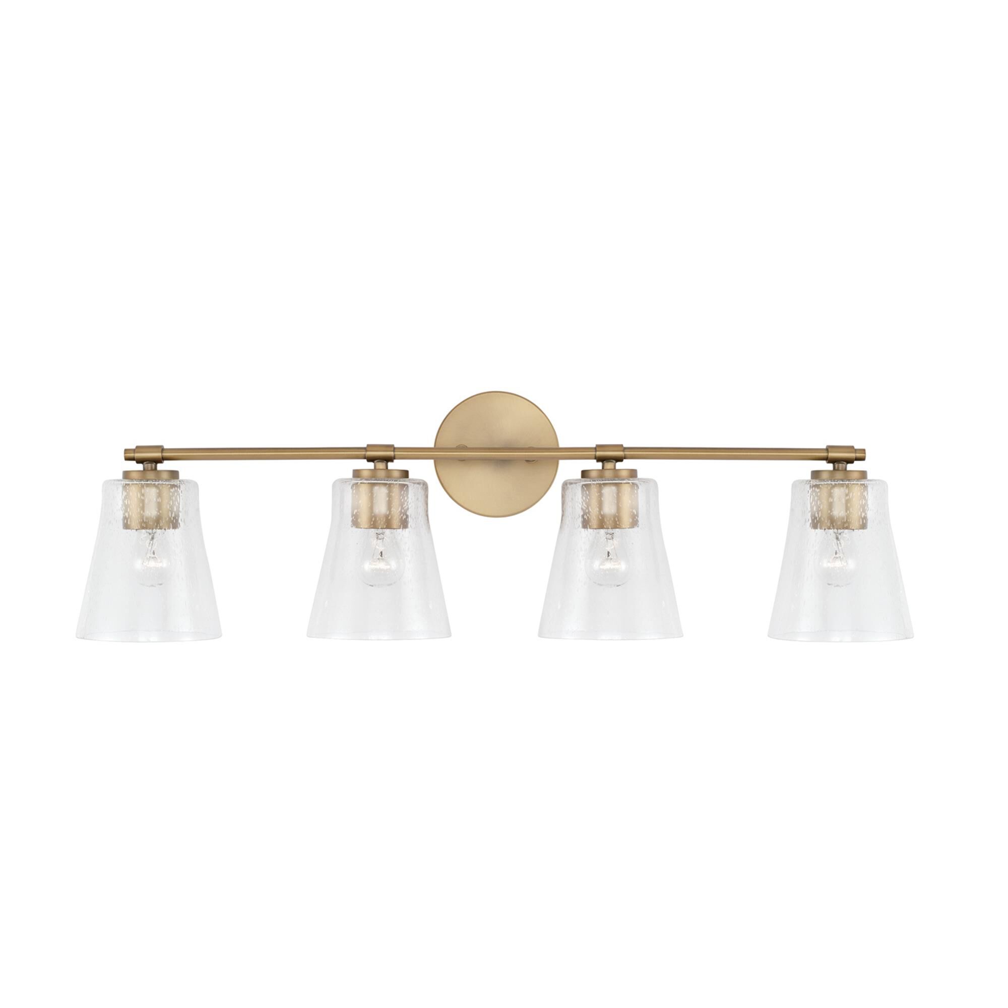 Shown in Aged Brass finish and Clear Seeded glass
