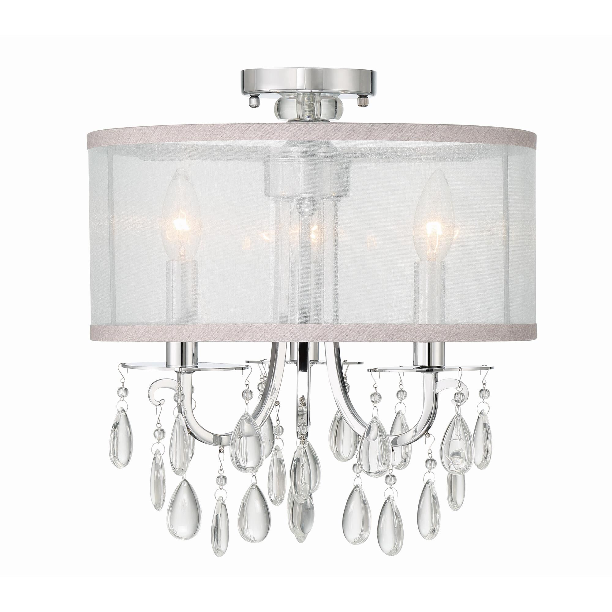 Shown in Polished Chrome finish and Clear Teardrop Almond crystal and Silk glass and Silk shade