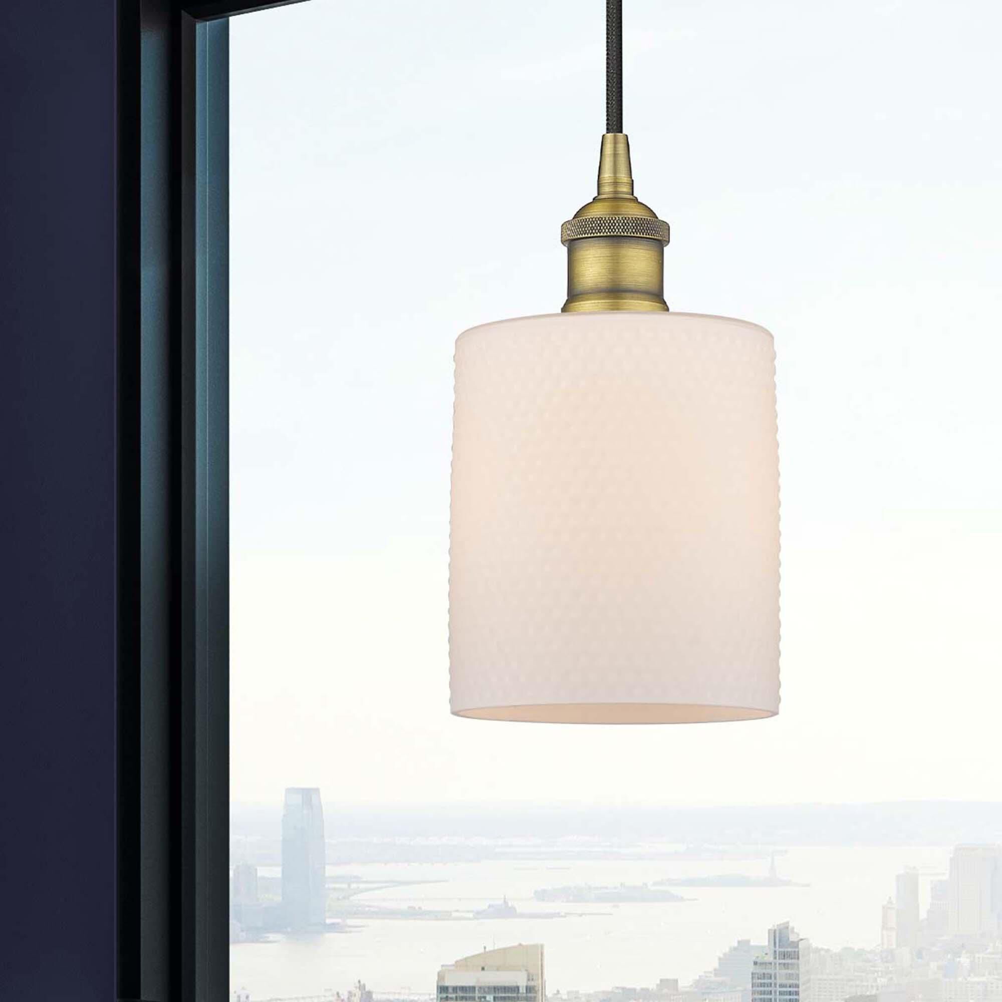 Shown in Brushed Brass finish and Matte White glass