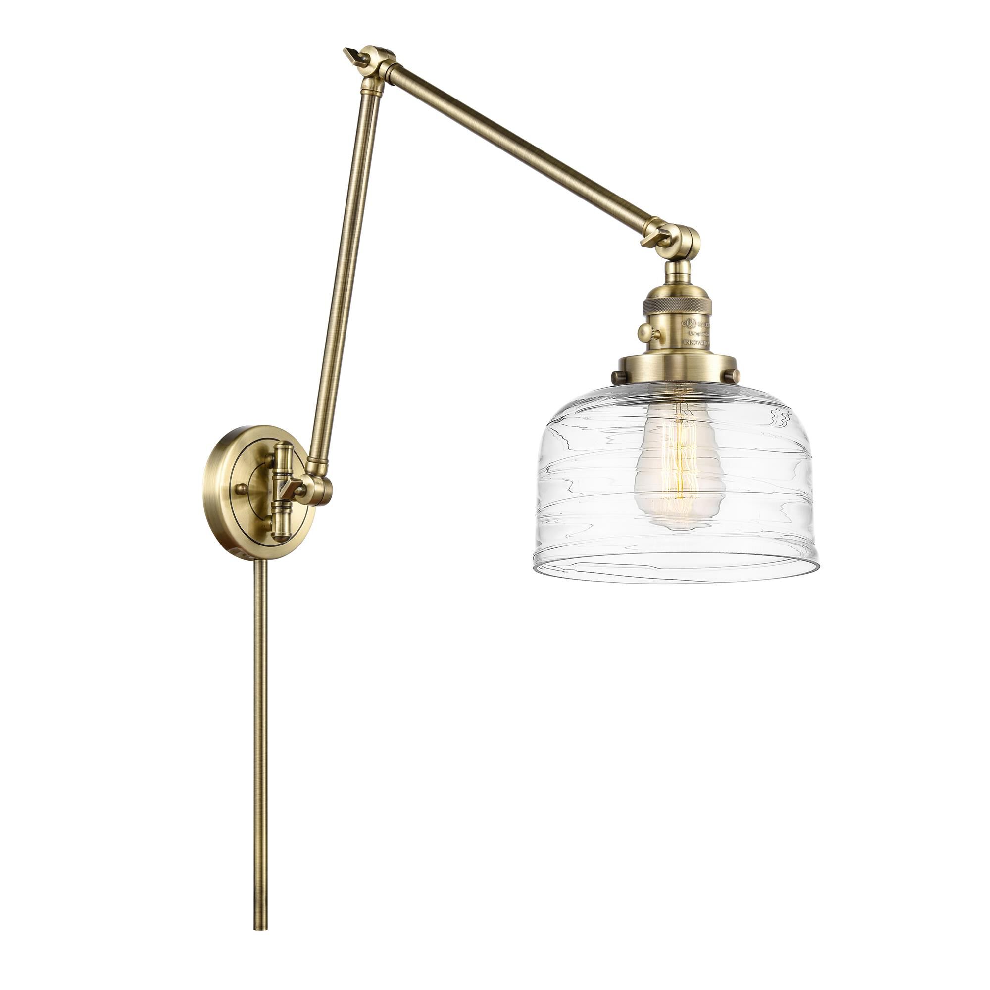 Shown in Antique Brass finish and Clear Deco Swirl Large Bell glass