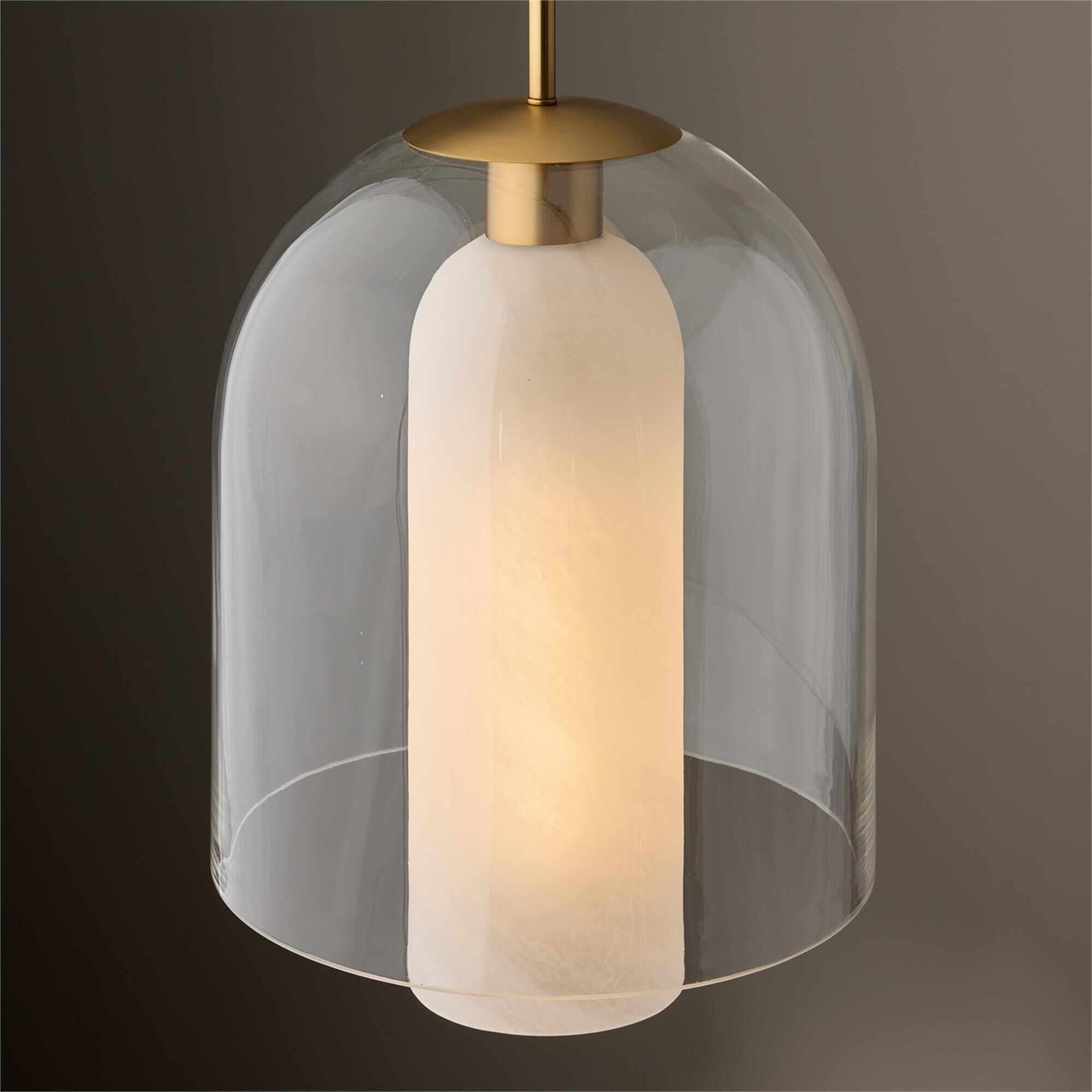 Shown in Aged Brass finish and Clear and Faux Alabaster glass