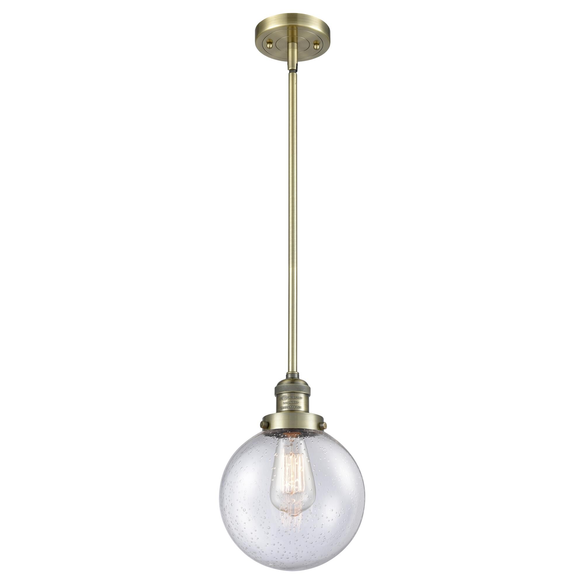 Shown in Antique Brass finish and Seedy glass