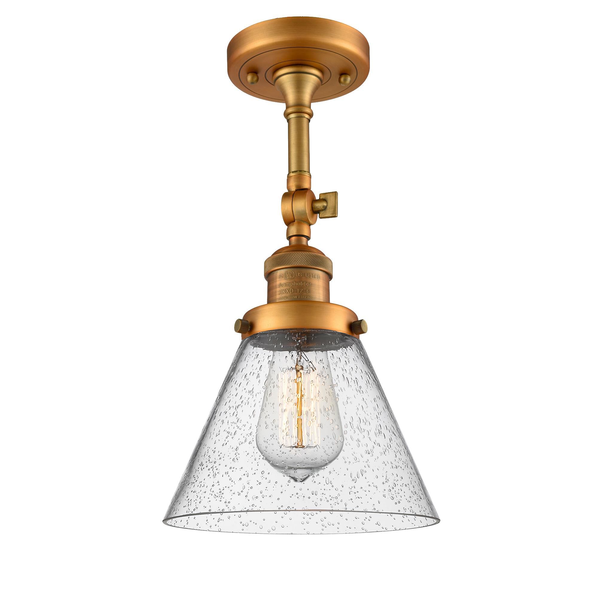 Shown in Brushed Brass finish and Seedy glass and None accent