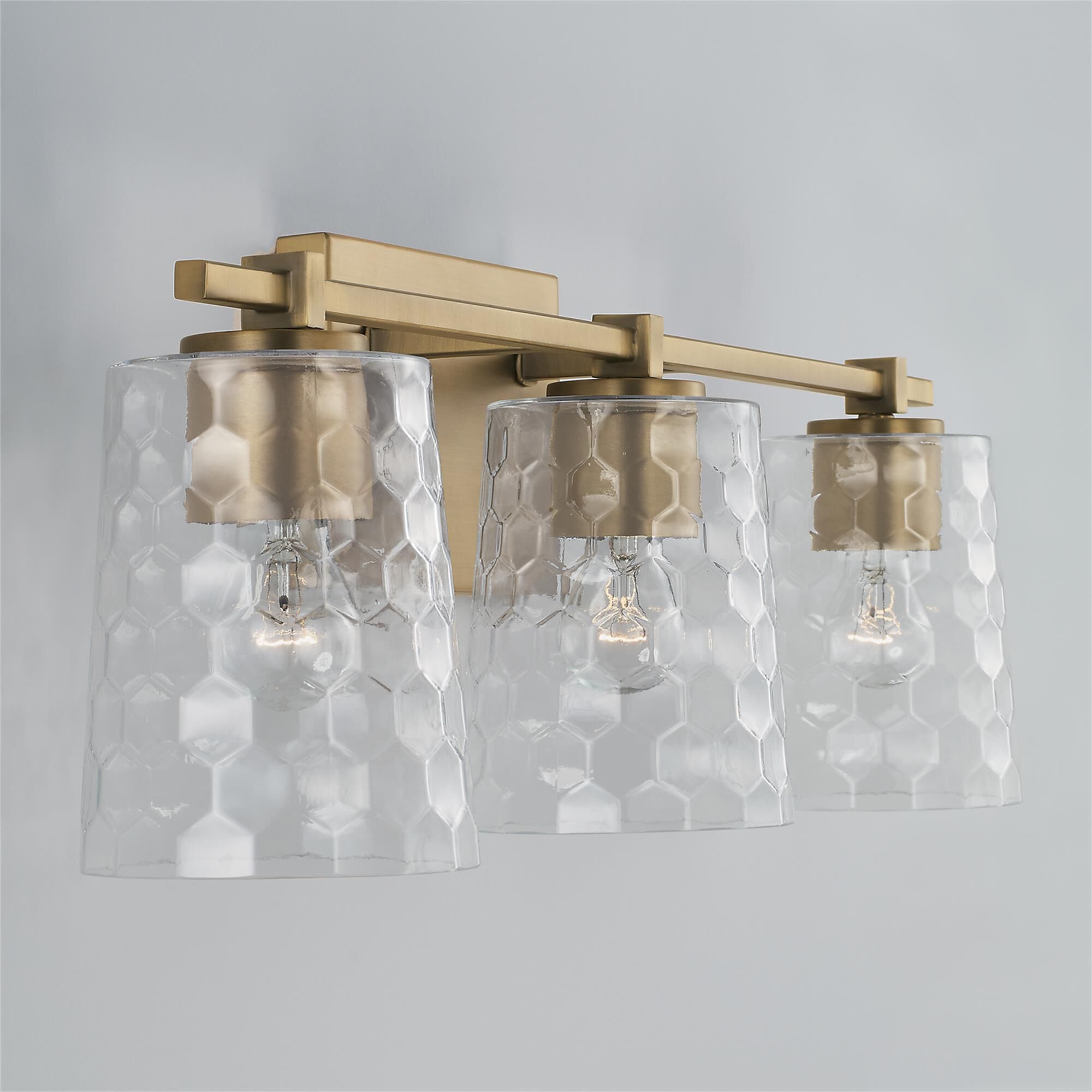 Shown in Aged Brass finish and Clear Honeycomb glass