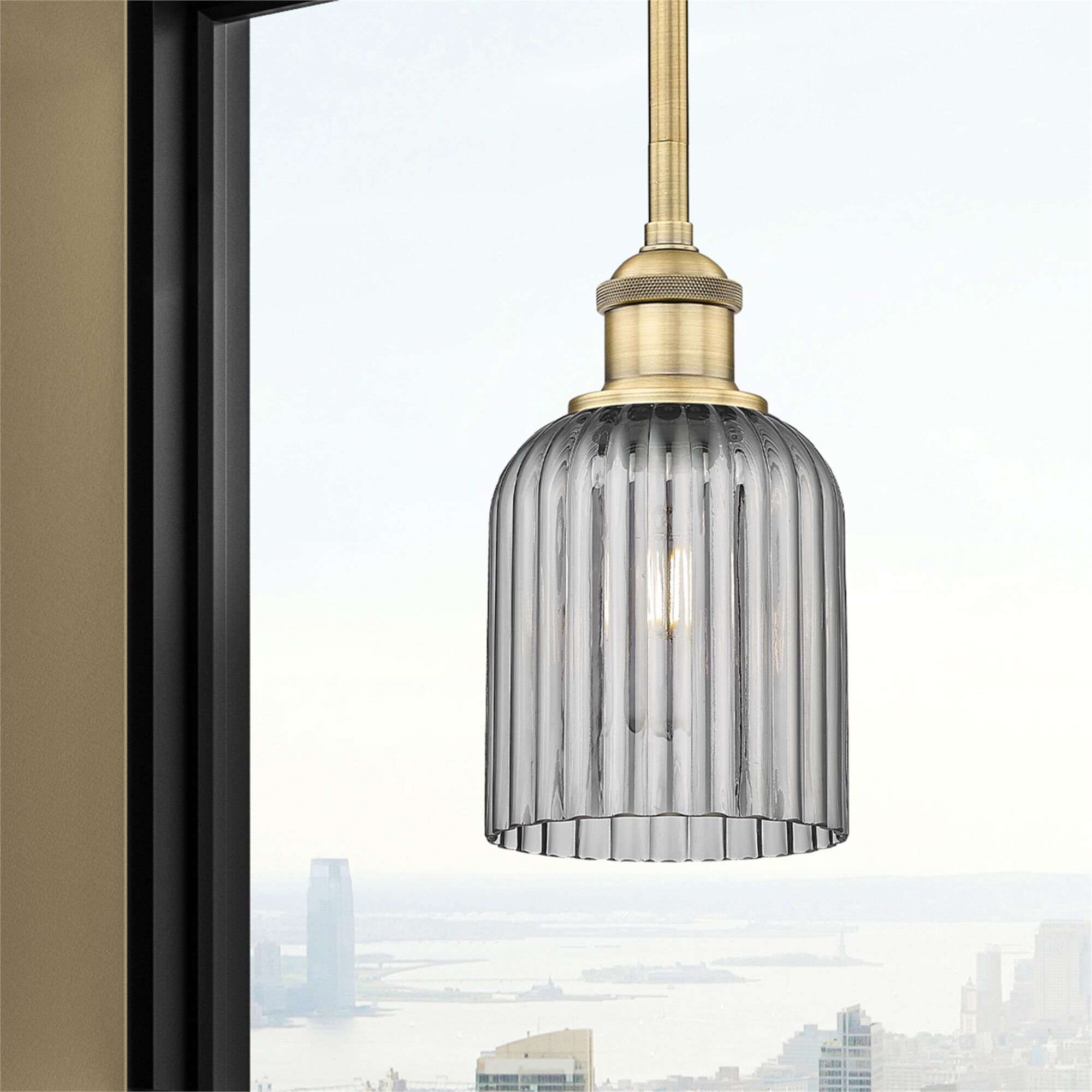 Shown in Brushed Brass finish and Light Smoke glass