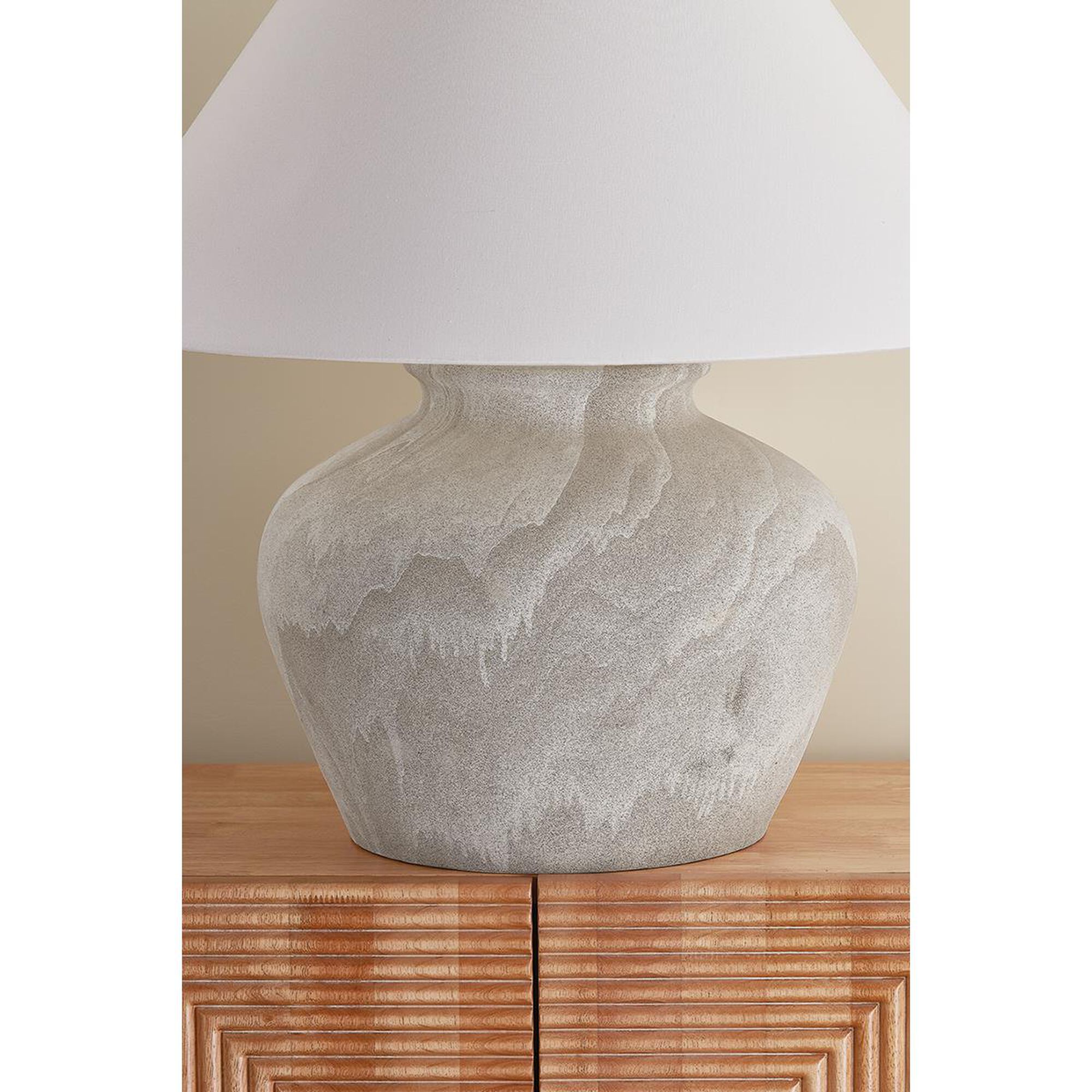 Shown in Aged Brass and Ceramic Watercolor Sand finish and White Linen shade