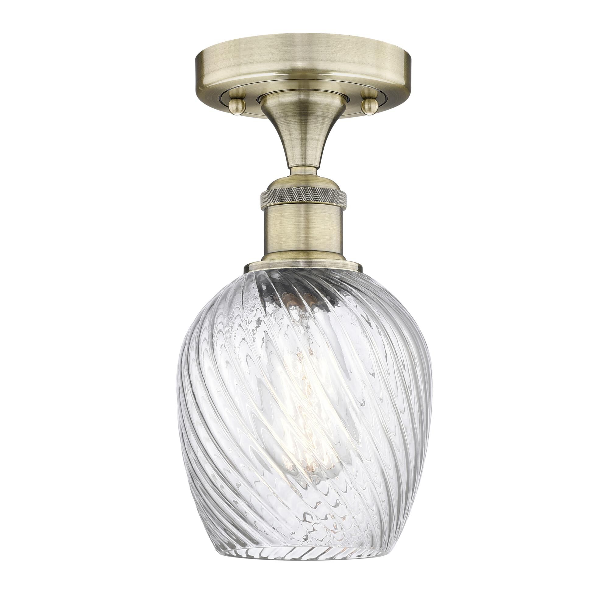 Shown in Antique Brass finish and Clear Spiral Fluted glass