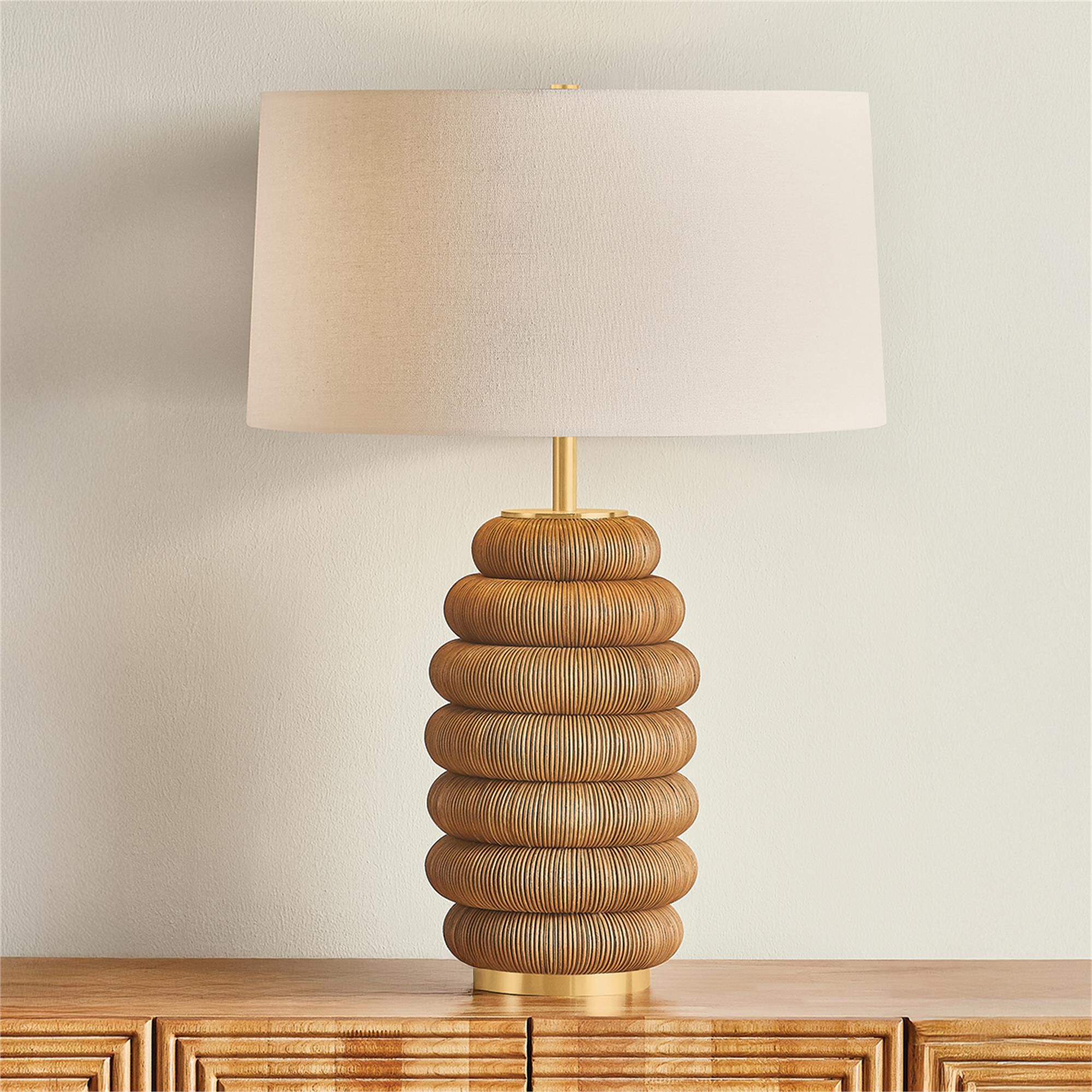 Shown in Aged Brass finish and White Linen shade