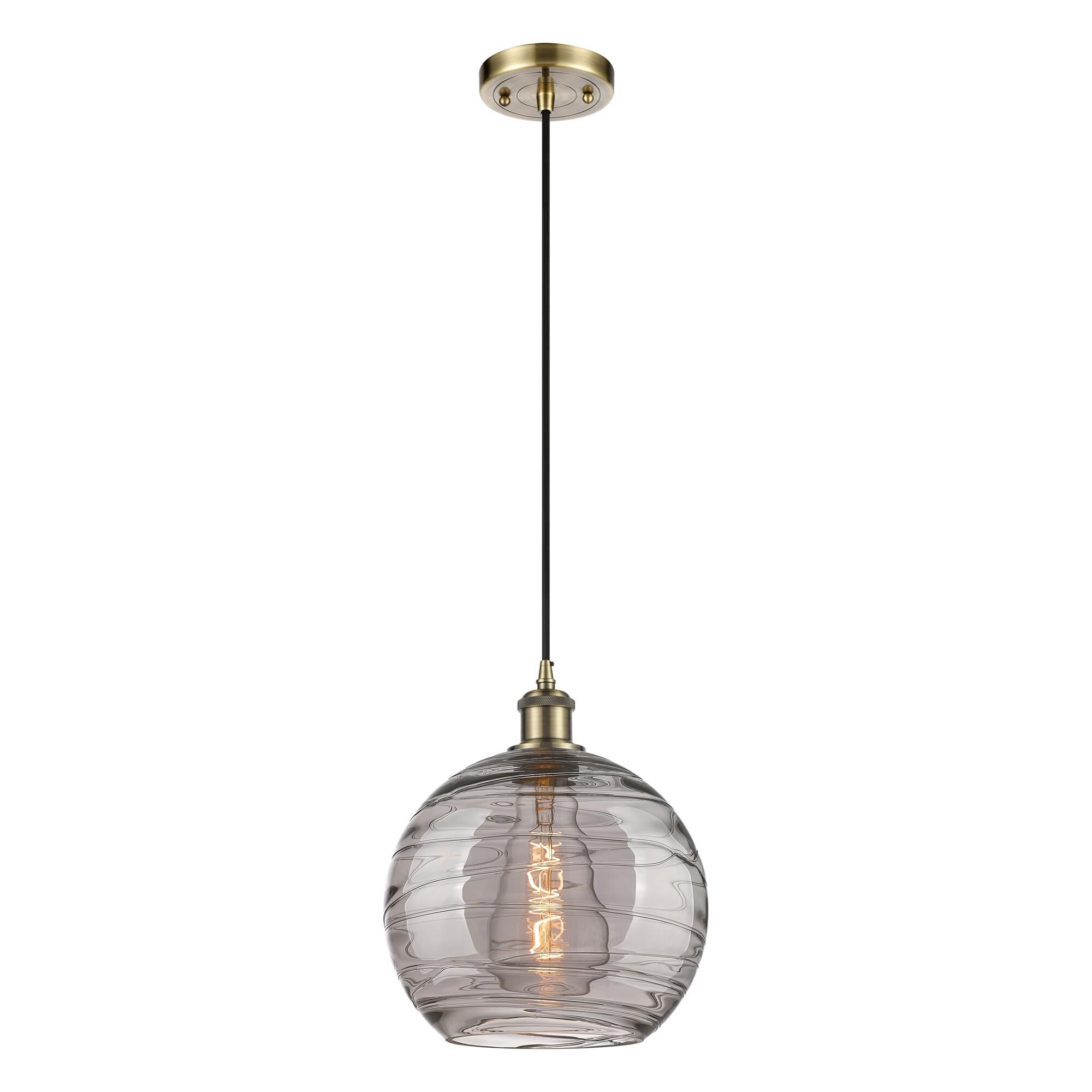 Shown in Antique Brass finish and Light Smoke Deco Swirl glass