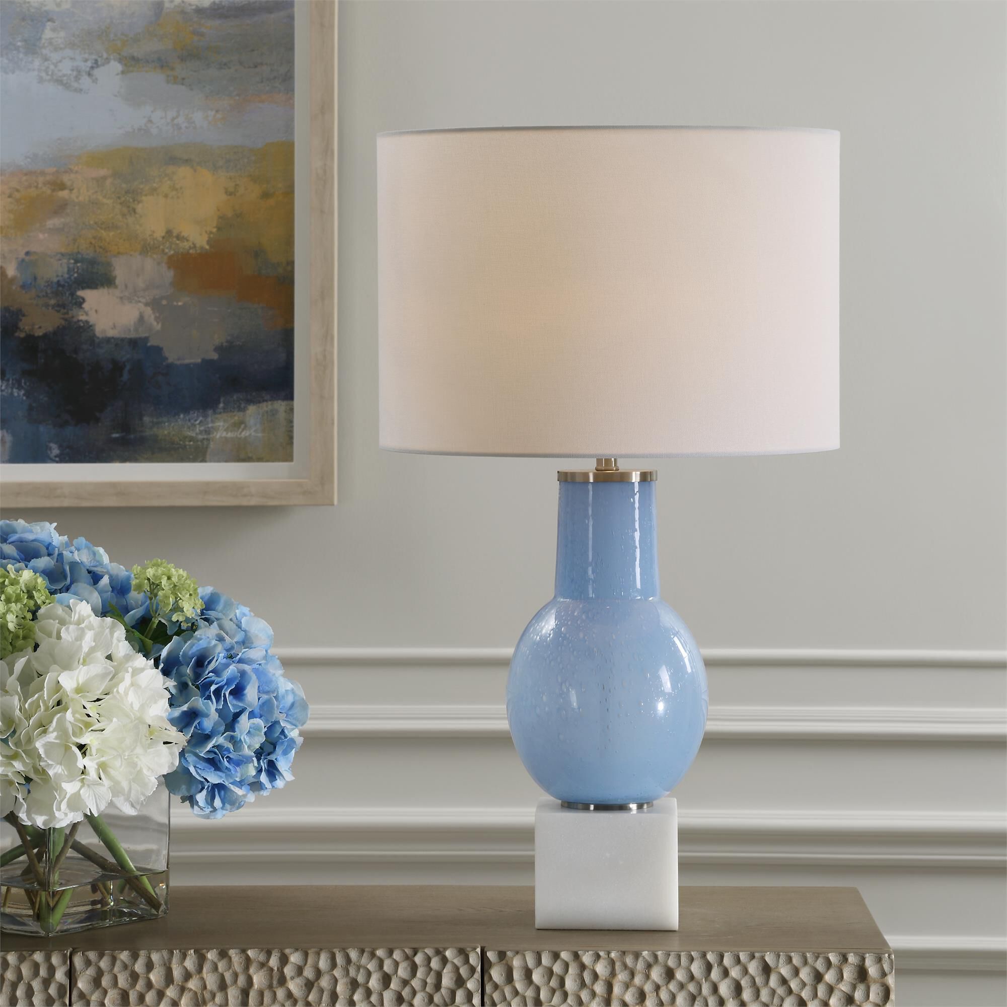Shown in This Table Lamp Features A Sky Blue Seeded Glass Body Atop A Sturdy White Marble Foot With Brushed N finish and Round Drum Hardback shade