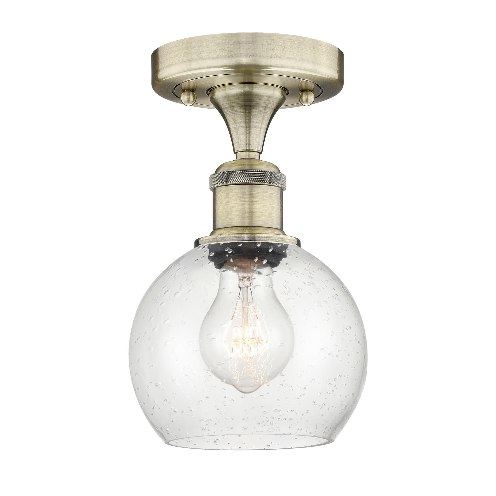 Shown in Antique Brass finish and Seedy glass