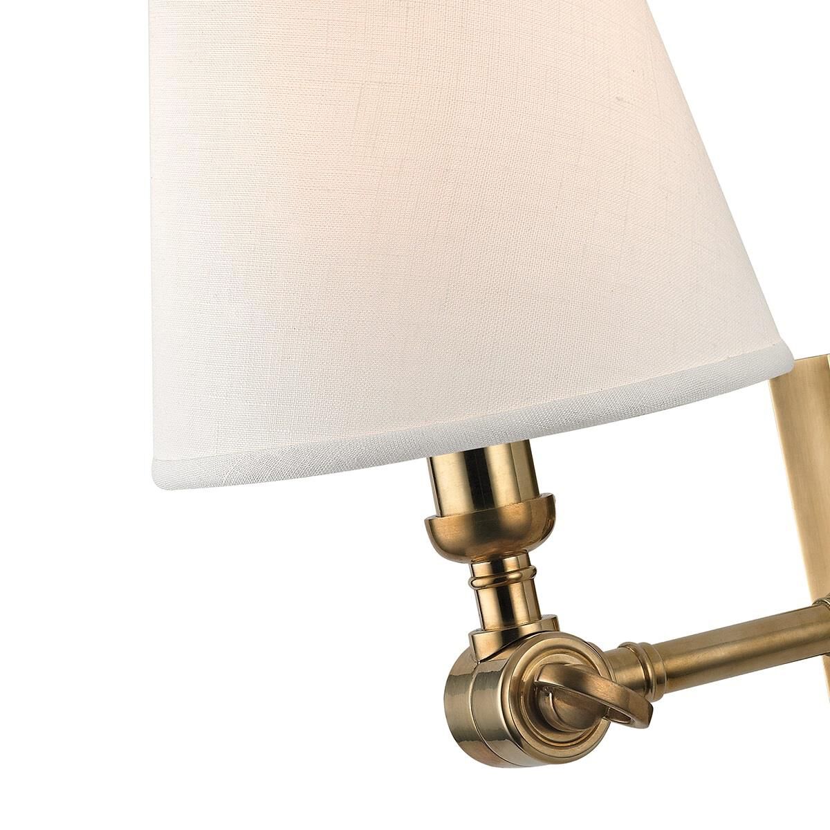 Shown in Aged Brass finish and White Linen shade