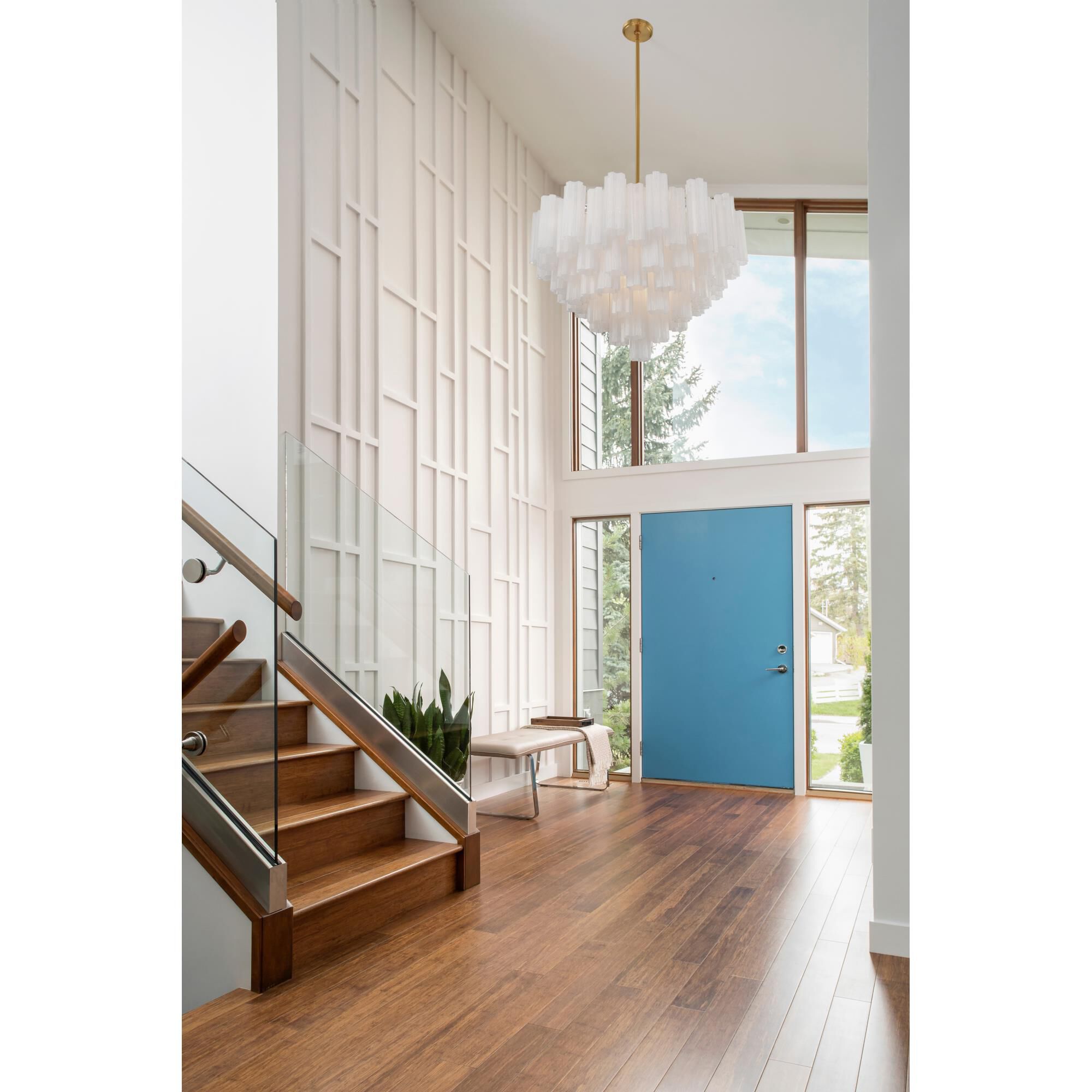 Shown in Aged Brass finish and Tronchi White glass