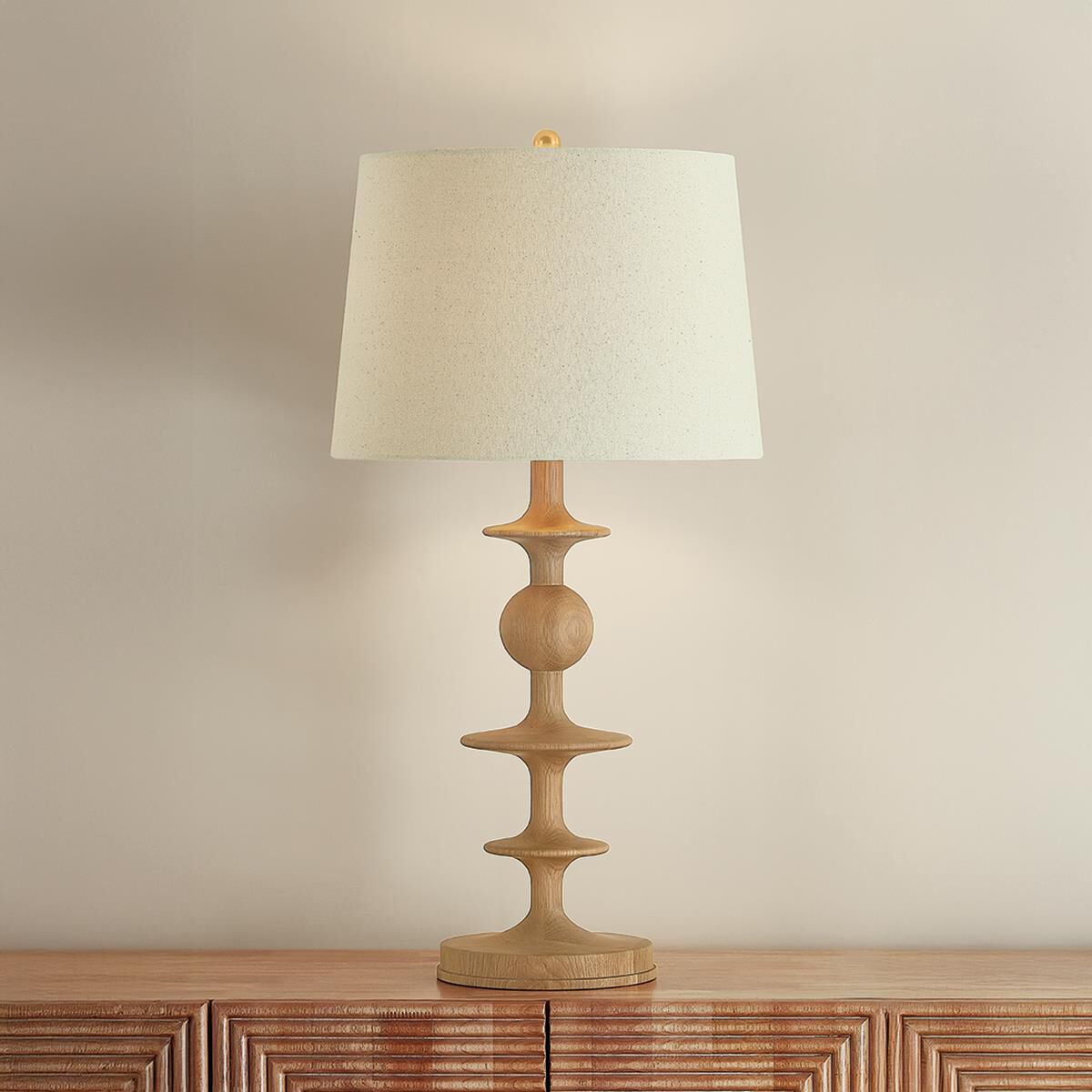 Shown in Aged Brass finish and Wheat Linen shade