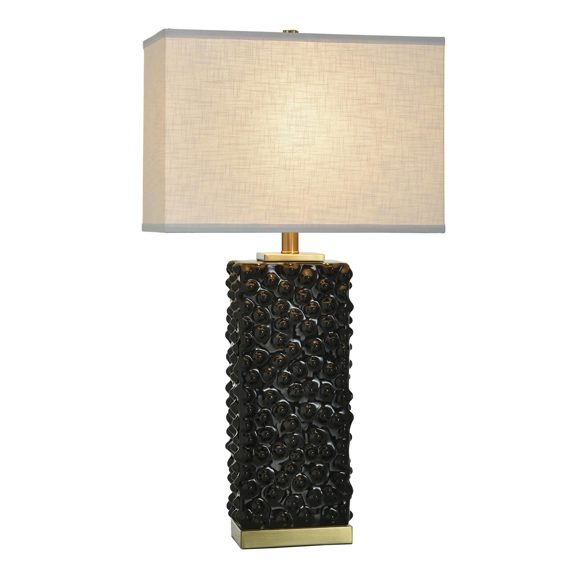 Shown in Polished Brass and Glossy Black finish and Off-White shade