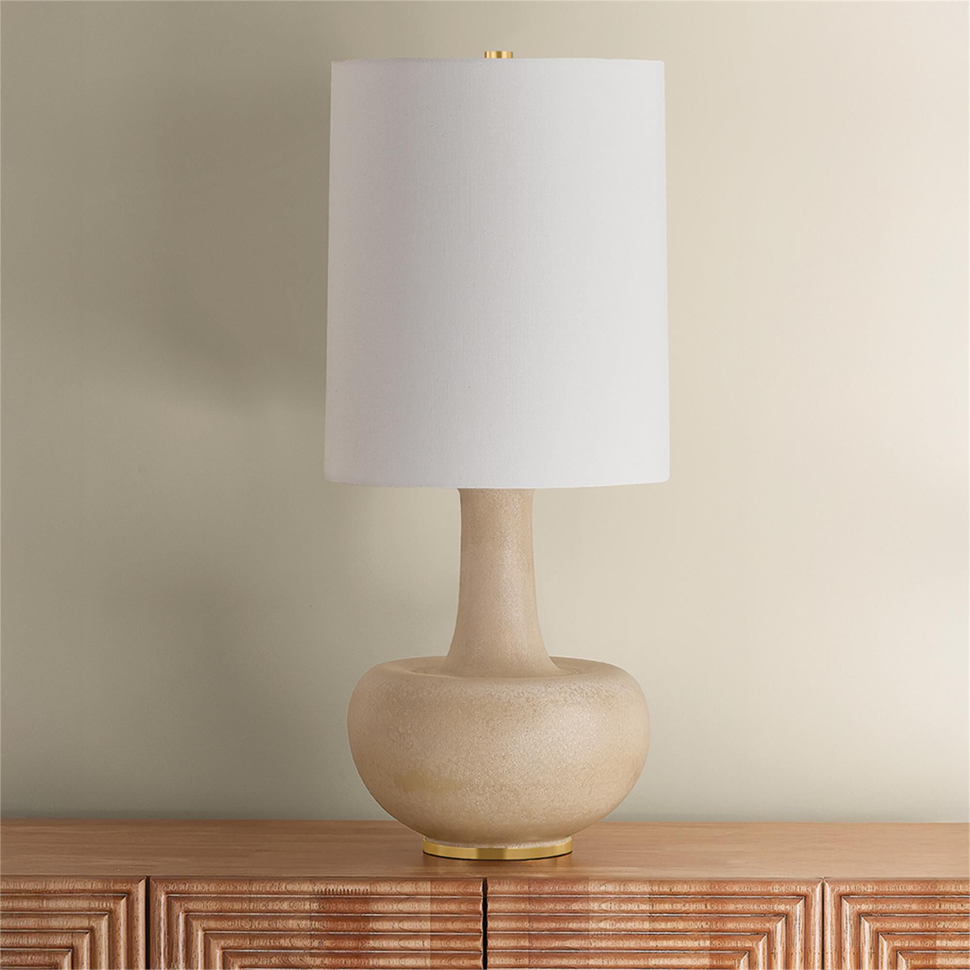 Shown in Aged Brass and Ceramic Biscotti Reactive finish and Textured Linen shade