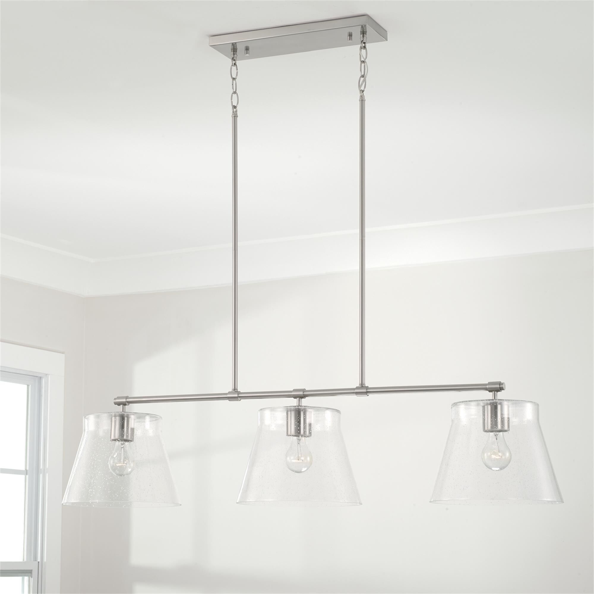Shown in Brushed Nickel finish and Clear Seeded glass