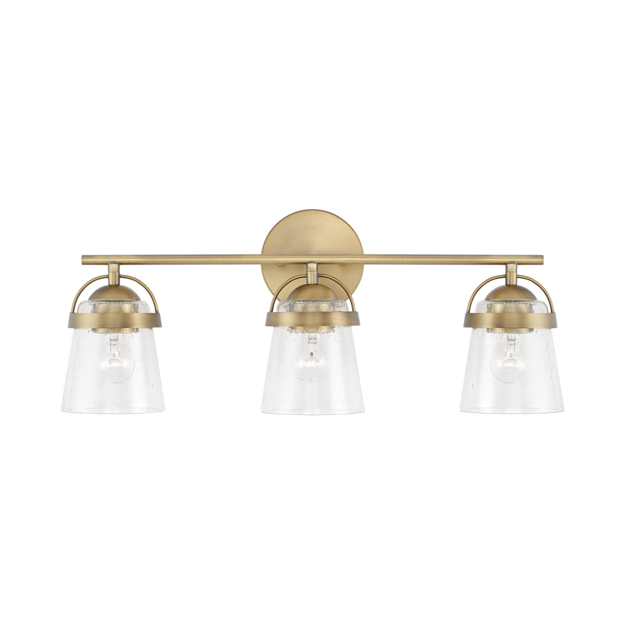 Shown in Aged Brass finish and Clear Seeded glass