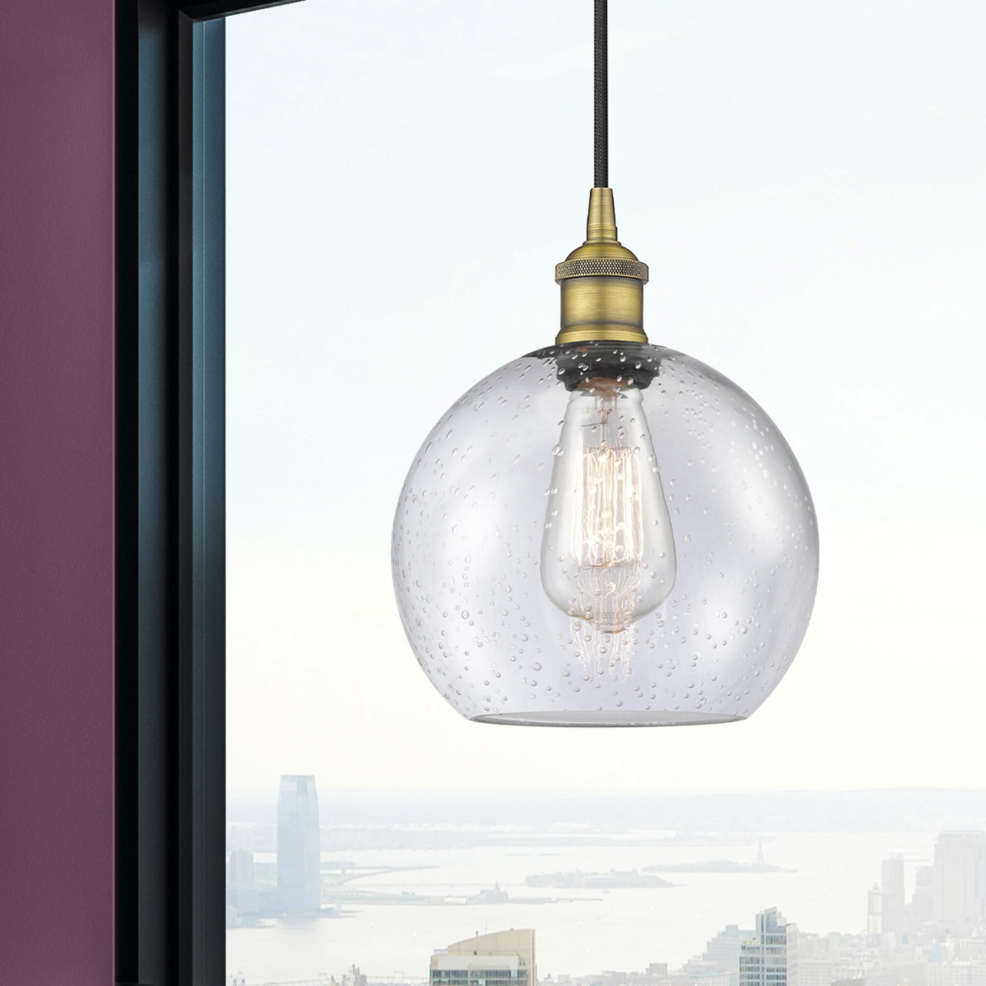 Shown in Brushed Brass finish and Seedy glass