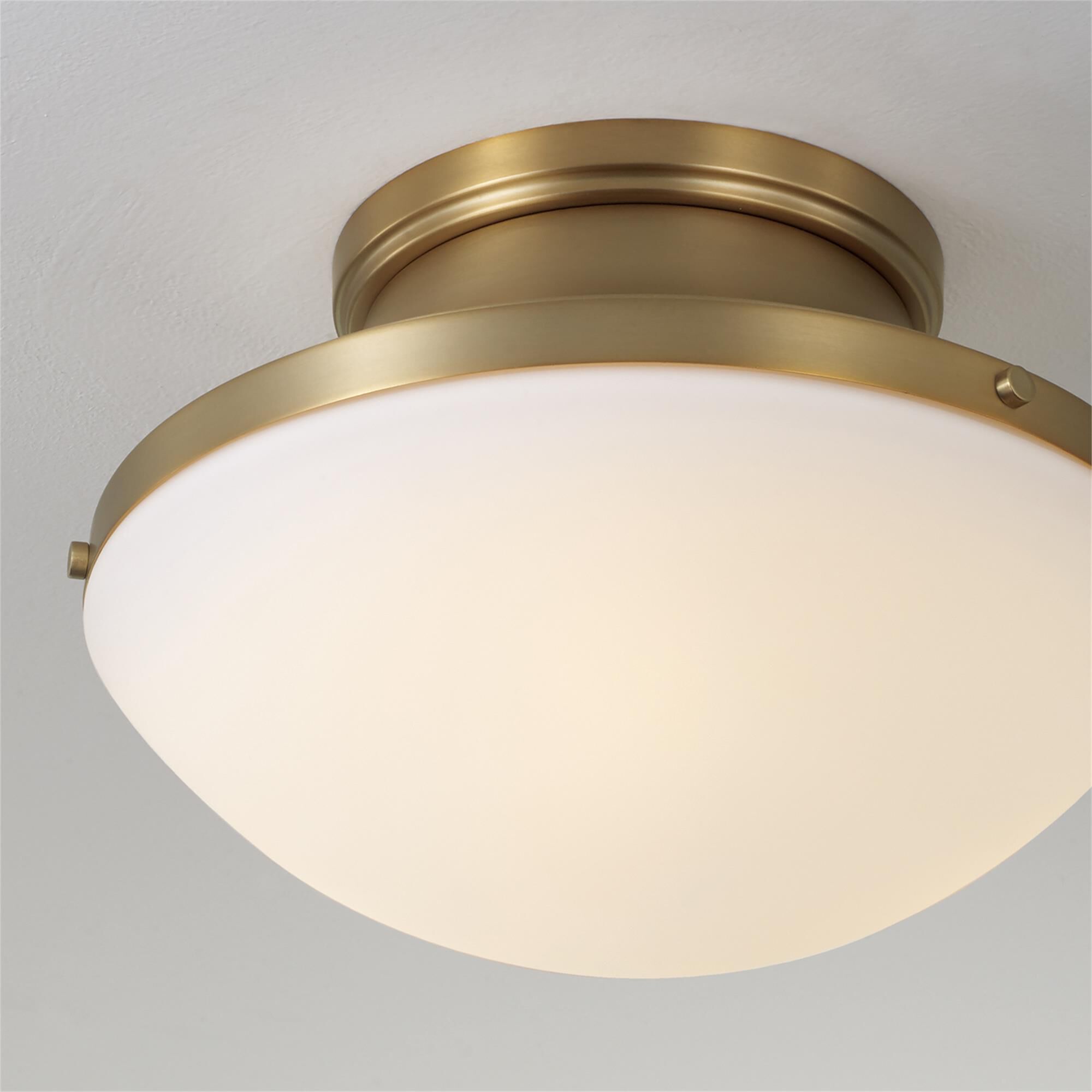 Shown in Aged Brass finish and Soft White glass