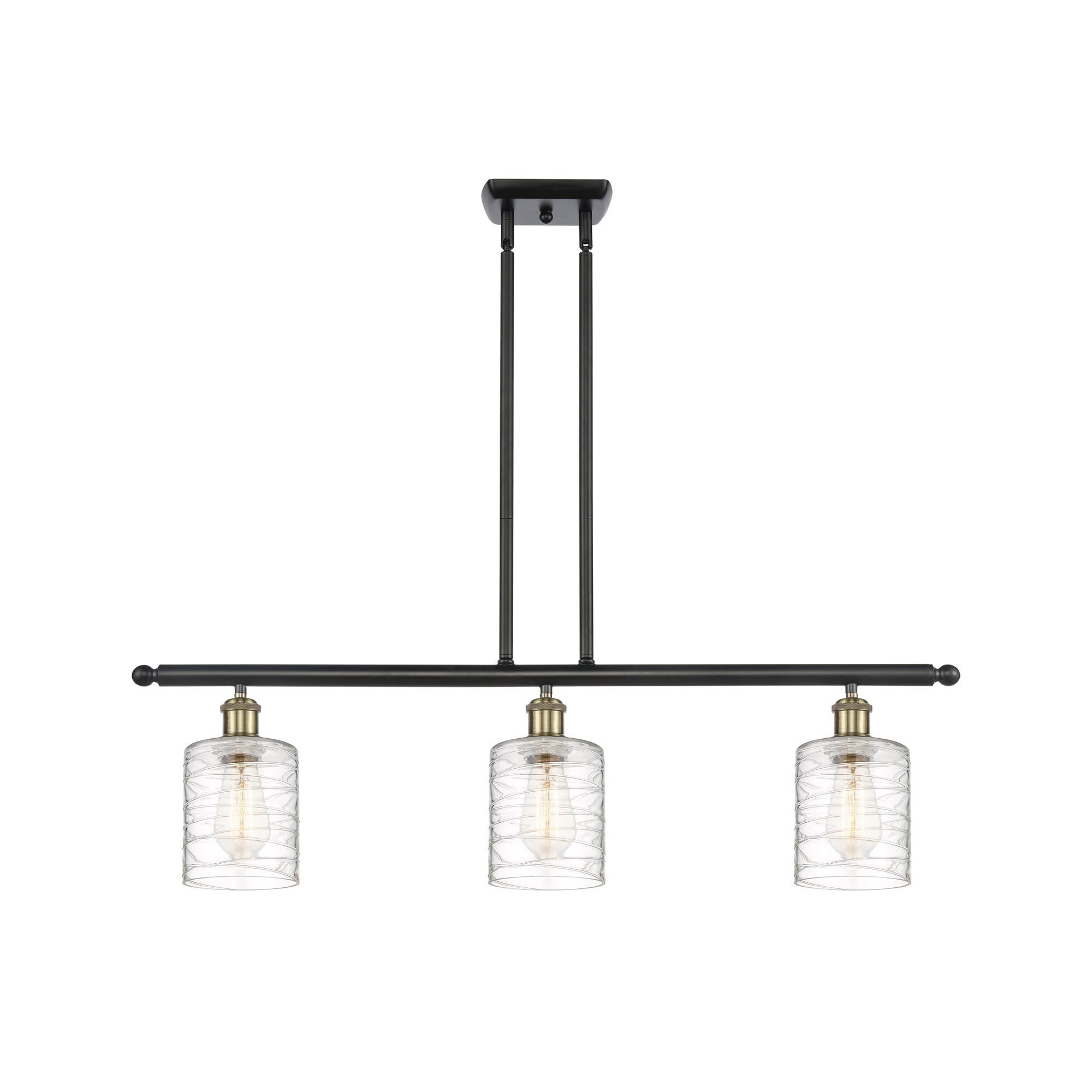 Shown in Black Antique Brass finish and Deco Swirl Cobbleskill glass