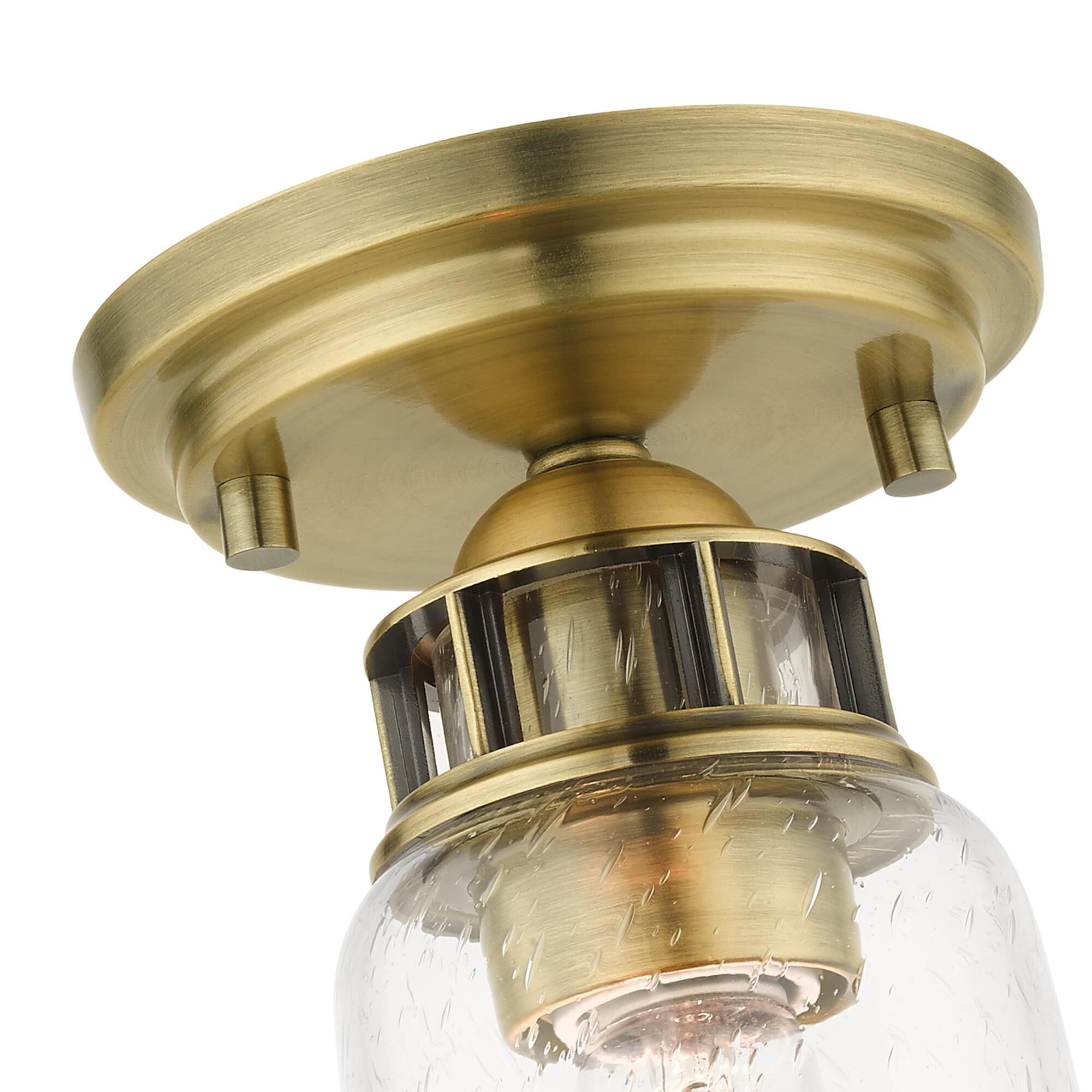 Shown in Antique Brass finish and Hand Blown Clear Seeded glass