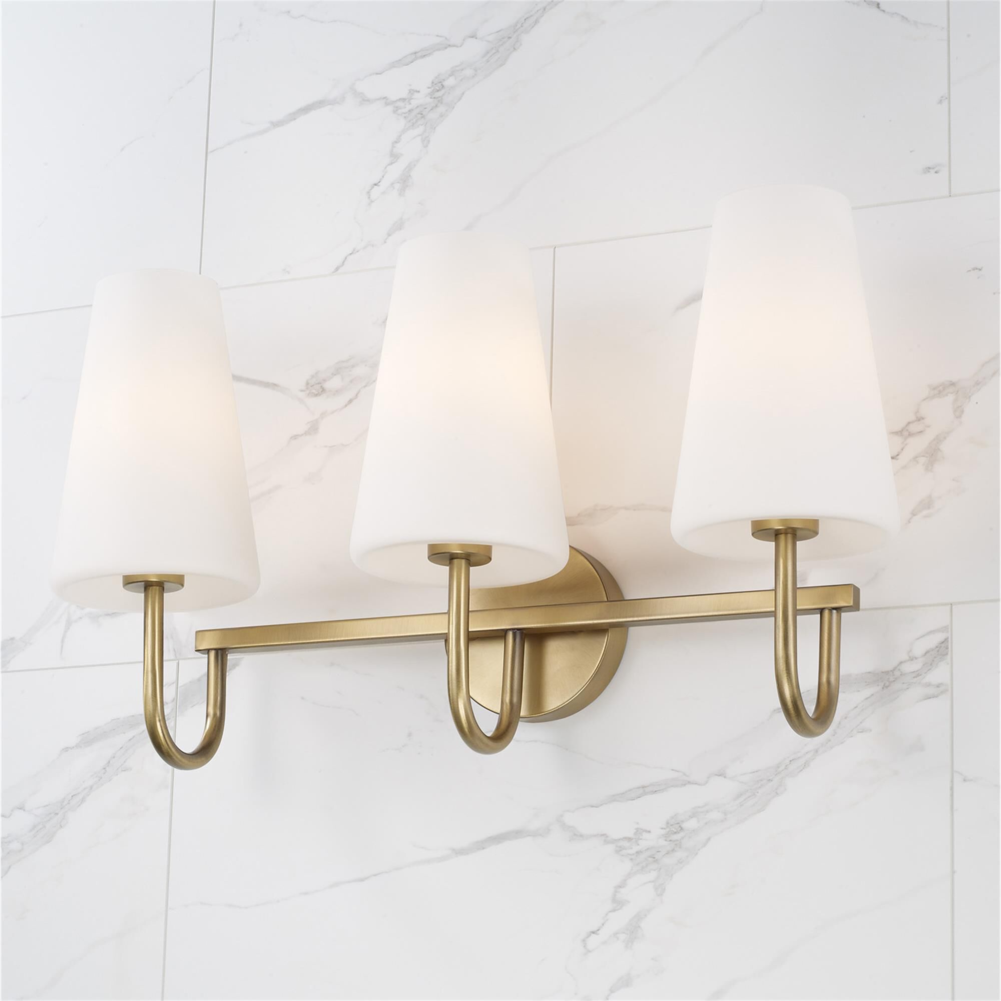 Shown in Aged Brass finish and Soft White glass