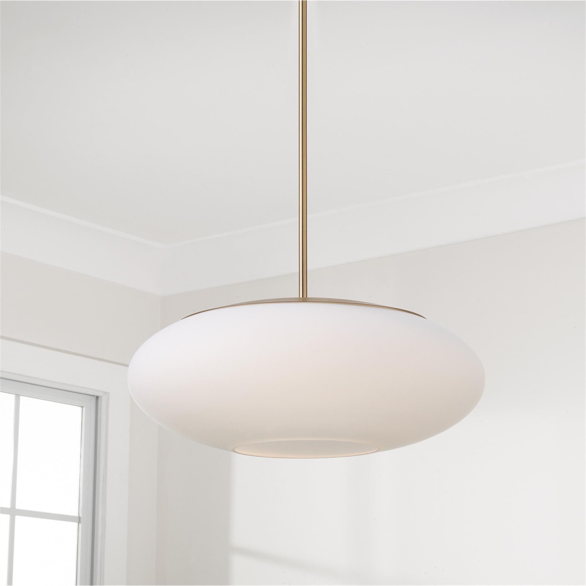 Shown in Aged Brass finish and Soft White glass