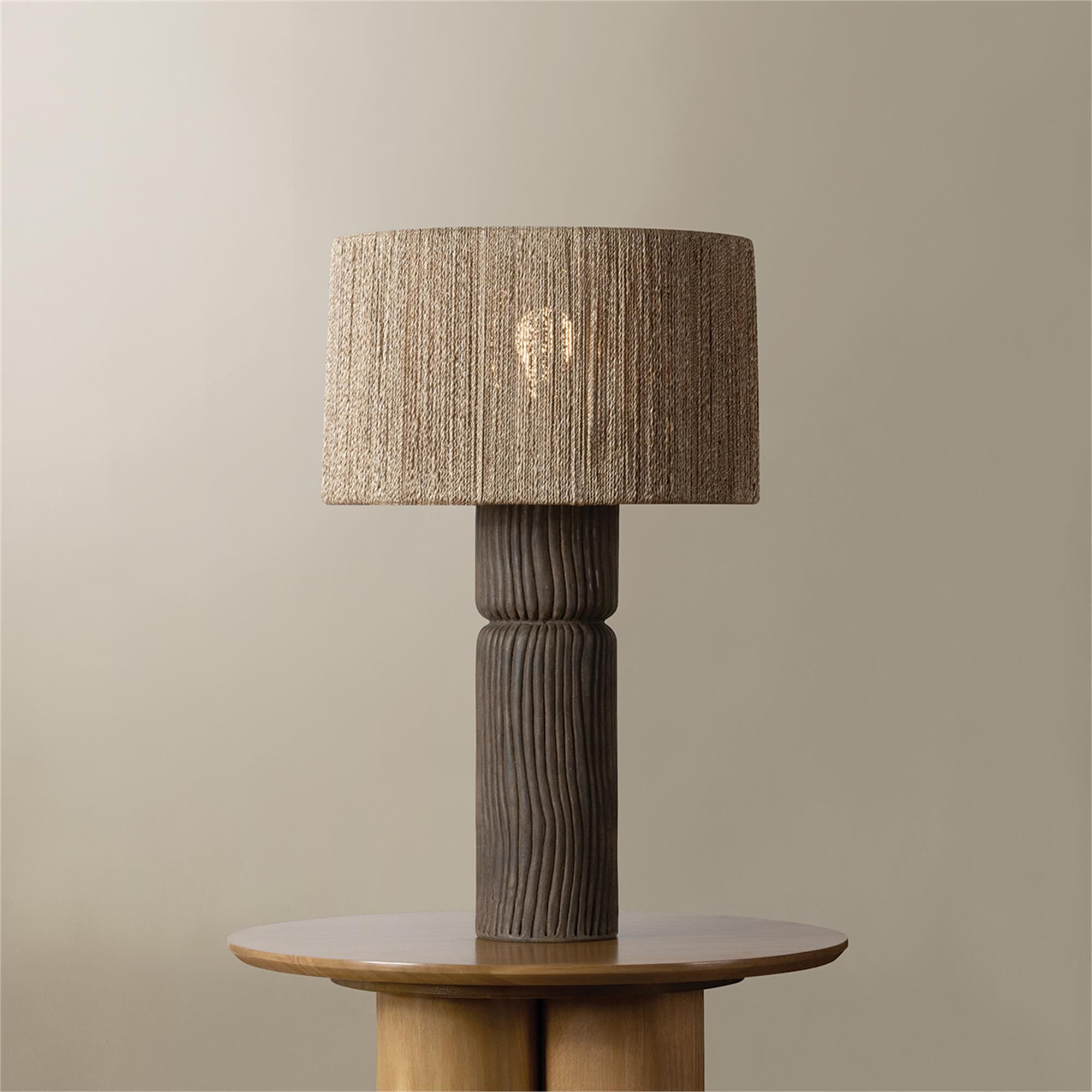Shown in Patina Brass and Ceramic Shadowed Bark finish and Abaca shade