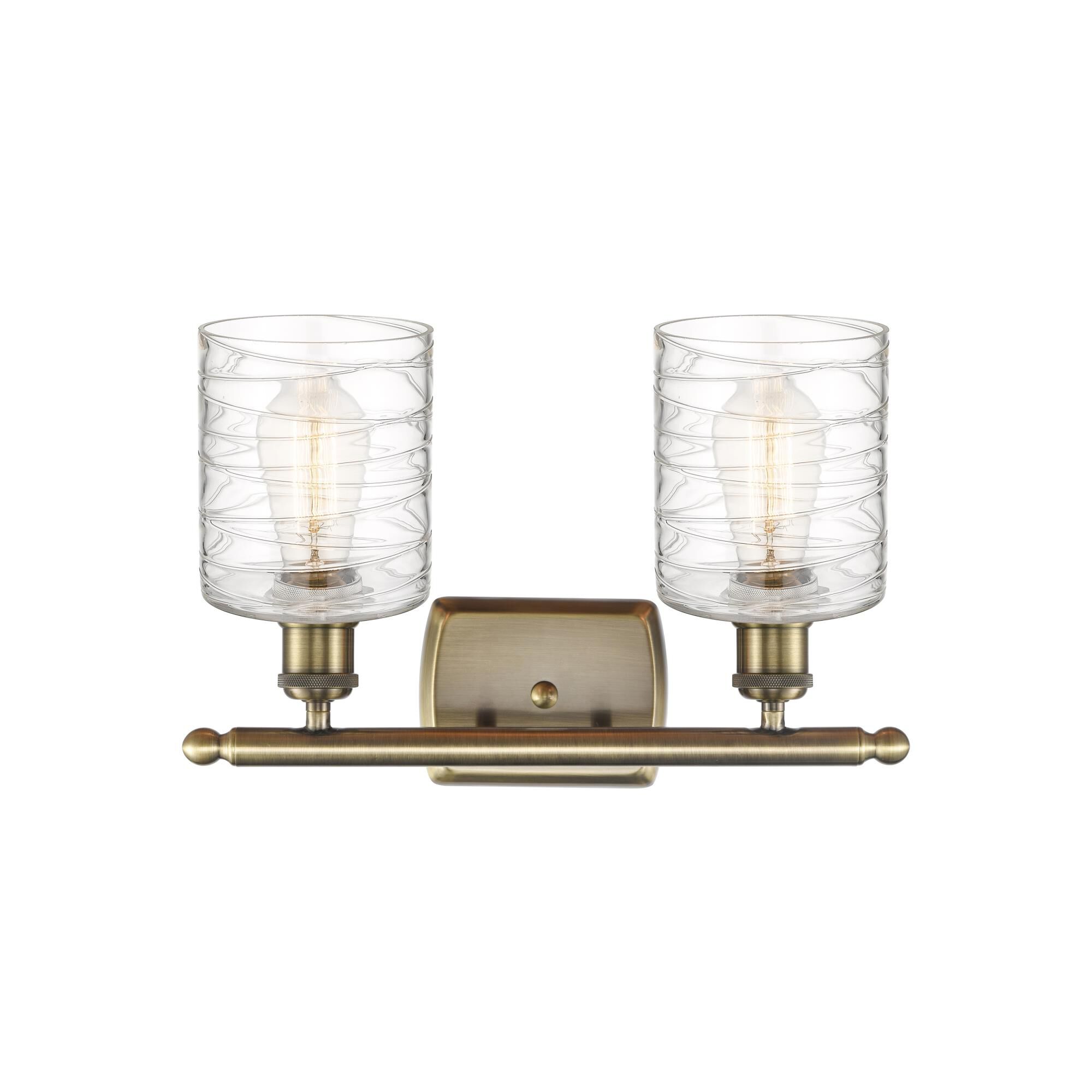Shown in Antique Brass finish and Deco Swirl glass
