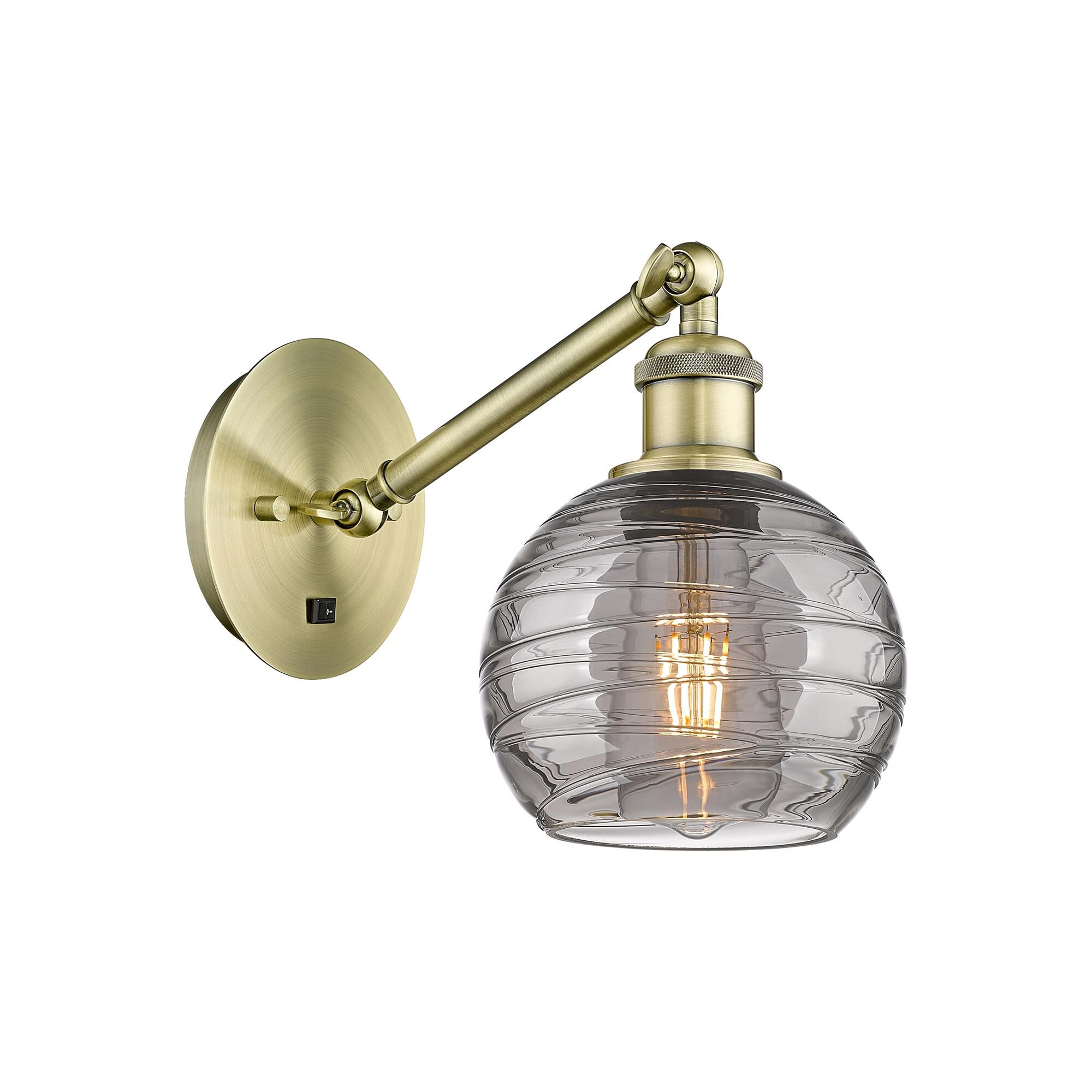 Shown in Antique Brass finish and Light Smoke Deco Swirl glass