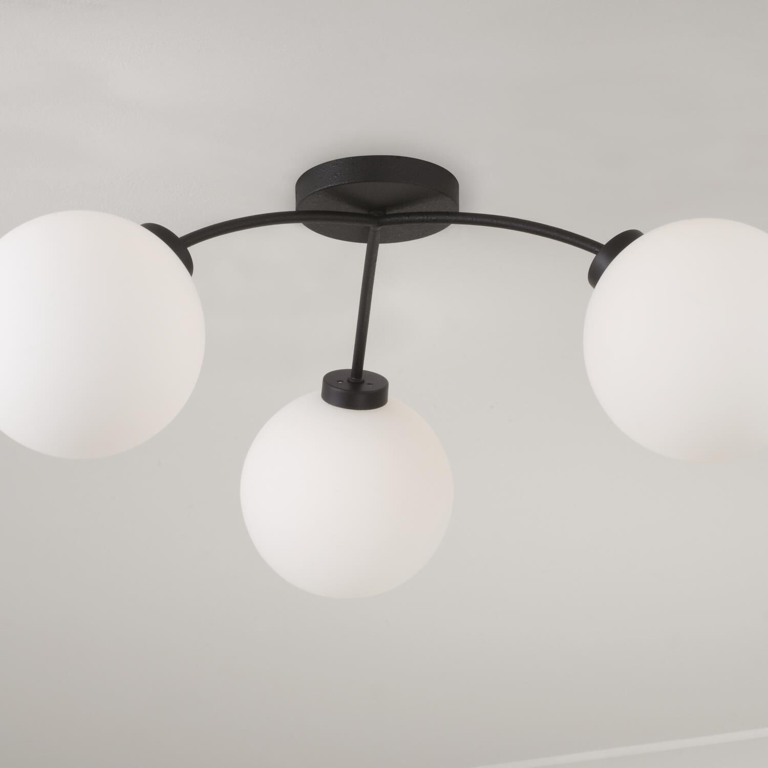 Shown in Black Iron finish and Soft White glass